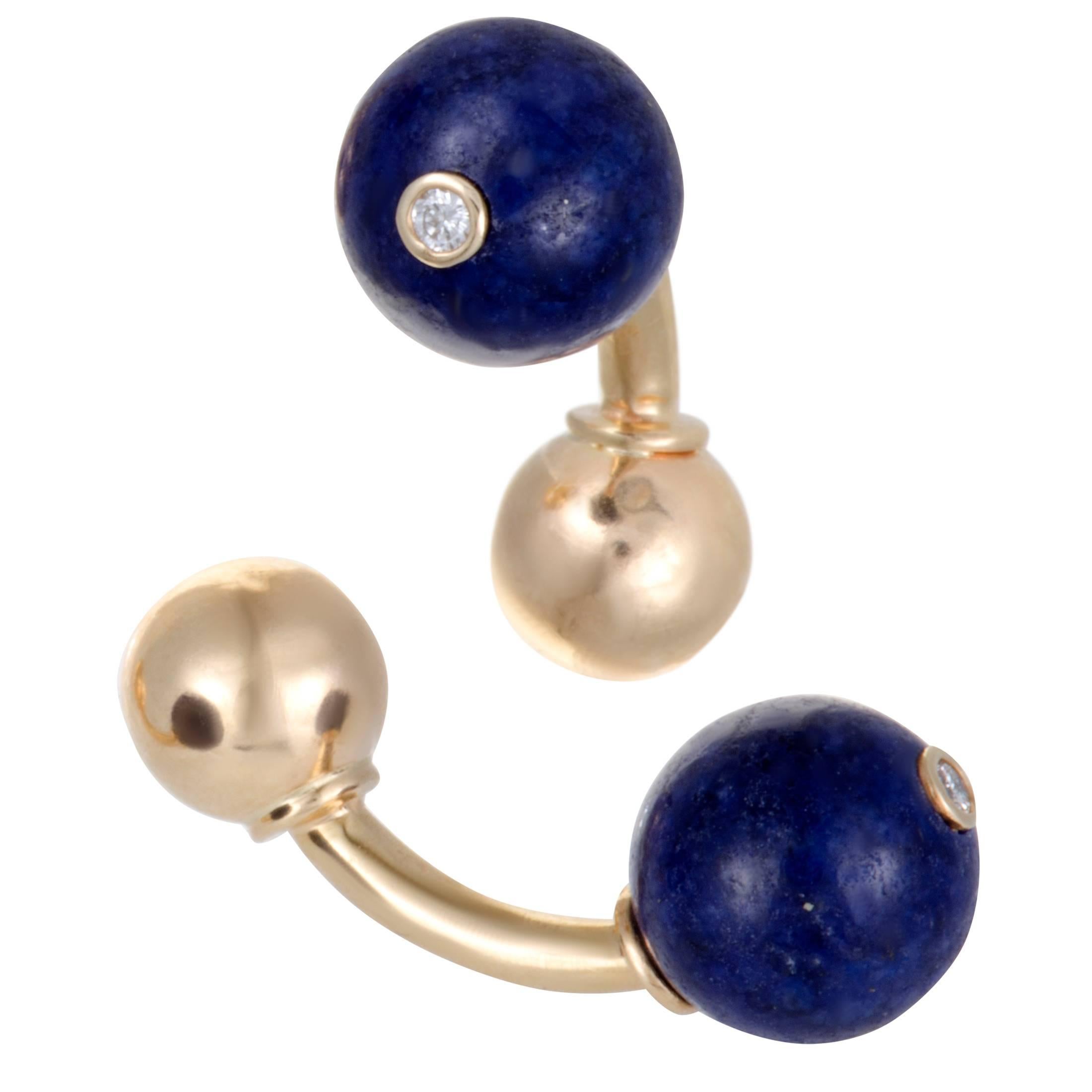 Elegantly designed by Tiffany & Co. in shimmering 18K yellow gold, this stunning pair of cufflinks ring is exemplary in design and style. The classy pair's design includes 0.06ct of sparkling diamonds and a captivating blue lapis lazuli stones that