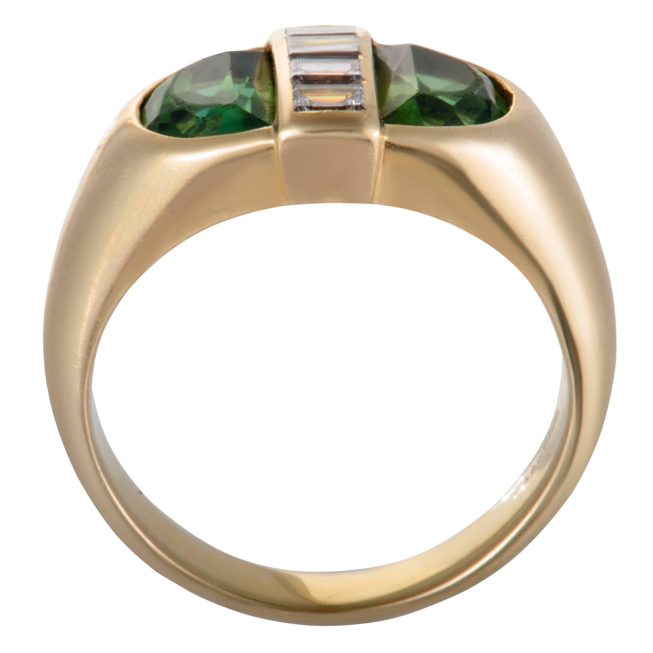 This beautiful ring by Tiffany & Co. is a spectacular blend of shimmering 18K yellow gold and a stunning design. The incredible ring includes 0.35ct of sparkling diamonds and spectacular green peridot stones in its gorgeous design that enhance the