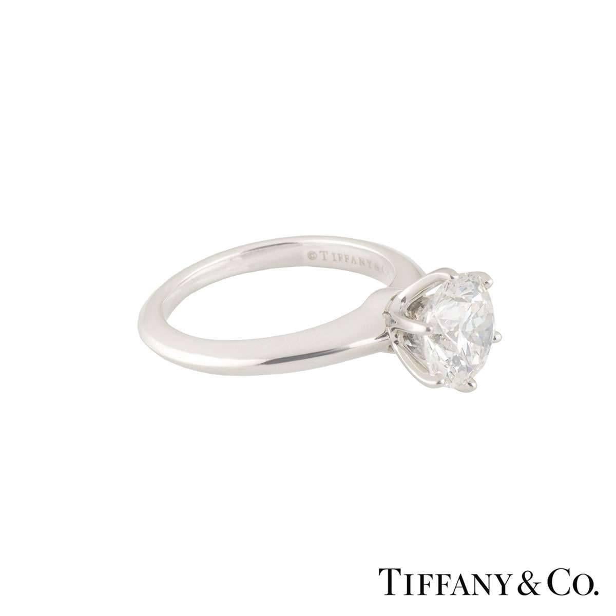 A beautiful Tiffany & Co. diamond engagement ring from The Tiffany Setting Band collection. The ring comprises of a round brilliant cut diamond in a prong setting with a weight of 1.76ct, H colour and VS2 clarity. The diamond scores an excellent