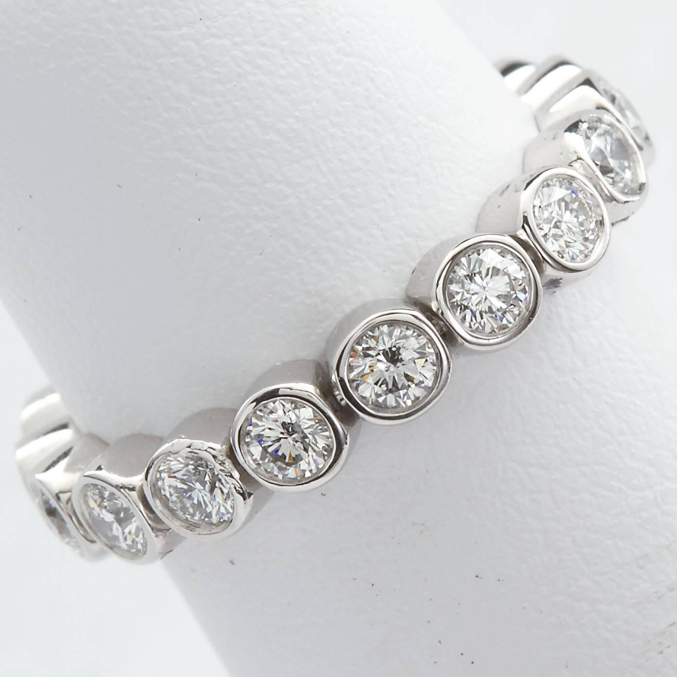 A very fine diamond in platinum flexing eternity band. Features eighteen (18) round brilliant cut diamonds in individual bezel style settings. Approx. 1.80 ctw. Signed T & Co. by Tiffany & Co. Ring size 5-1/2 US. The ring is clean and beautiful with