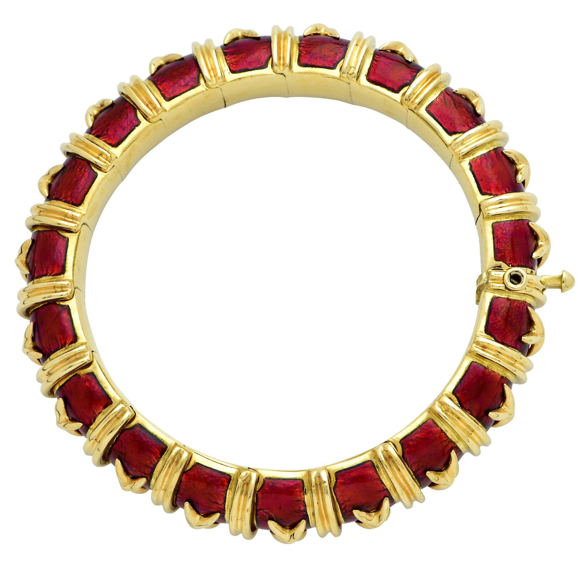 Stunning Tiffany And Co Schlumberger bangle from the crossillion collection, crafted in 18k yellow gold and enriched with Vibrant crimsom red enamel, accented with gold X’s and double piped borders surrounding the entire bracelet. The bracelet