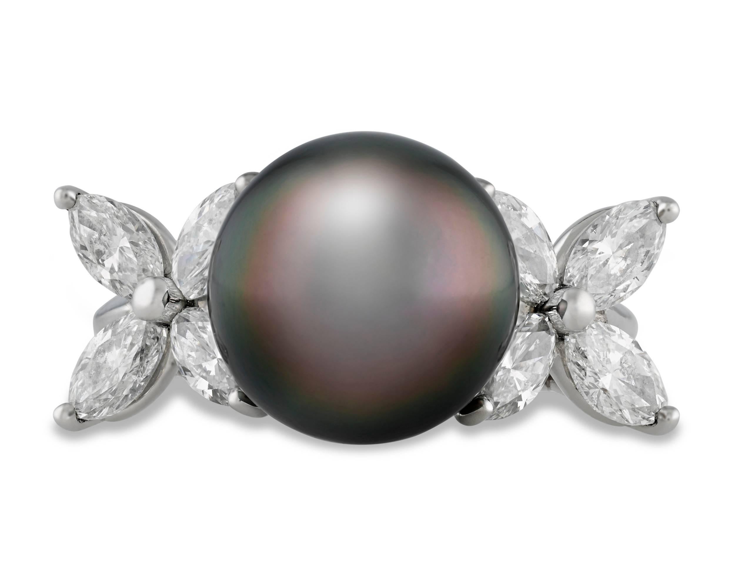 A breathtaking 11.6mm Tahitian black pearl showcases its mesmerizing beauty in this elegant Tiffany & Co. ring. Encircled by 1.59 carats of white diamonds in its dazzling platinum setting, this pearl displays the peerless depth and glow accomplished