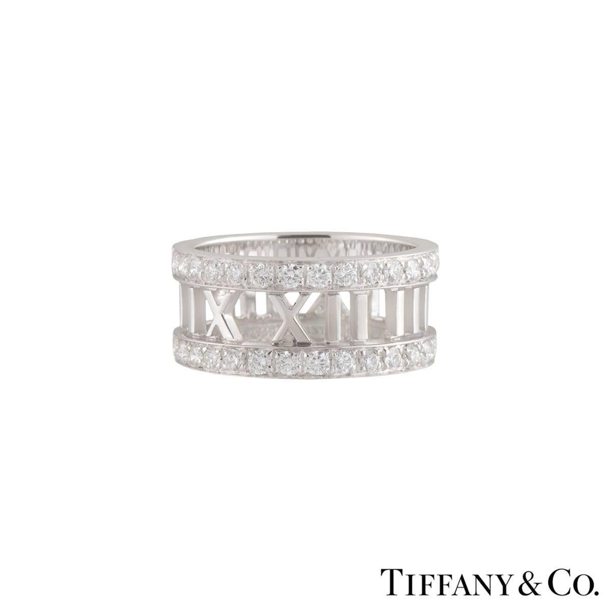 A beautiful 18k white gold diamond Tiffany & Co. dress ring from the Atlas collection. The ring comprises of the the iconic open work atlas motif around the ring with round brilliant cut diamonds set on the top and bottom of the band. There are 30