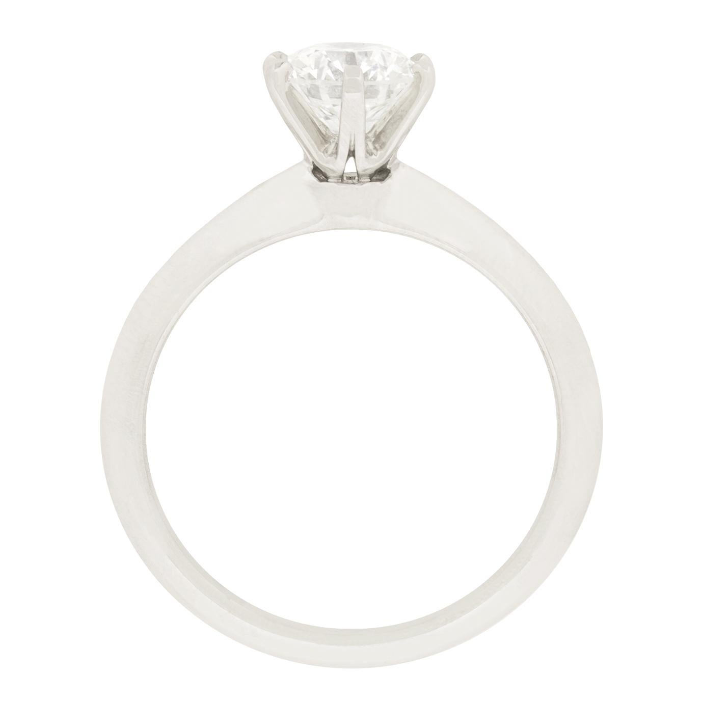One of the most iconic Tiffany & Co. pieces, this solitaire features the knife edge band synonymous with the brand. It is set with a 0.83 carat round brilliant diamond of the highest quality. Being graded F in colour and VS2 in clarity. The band is