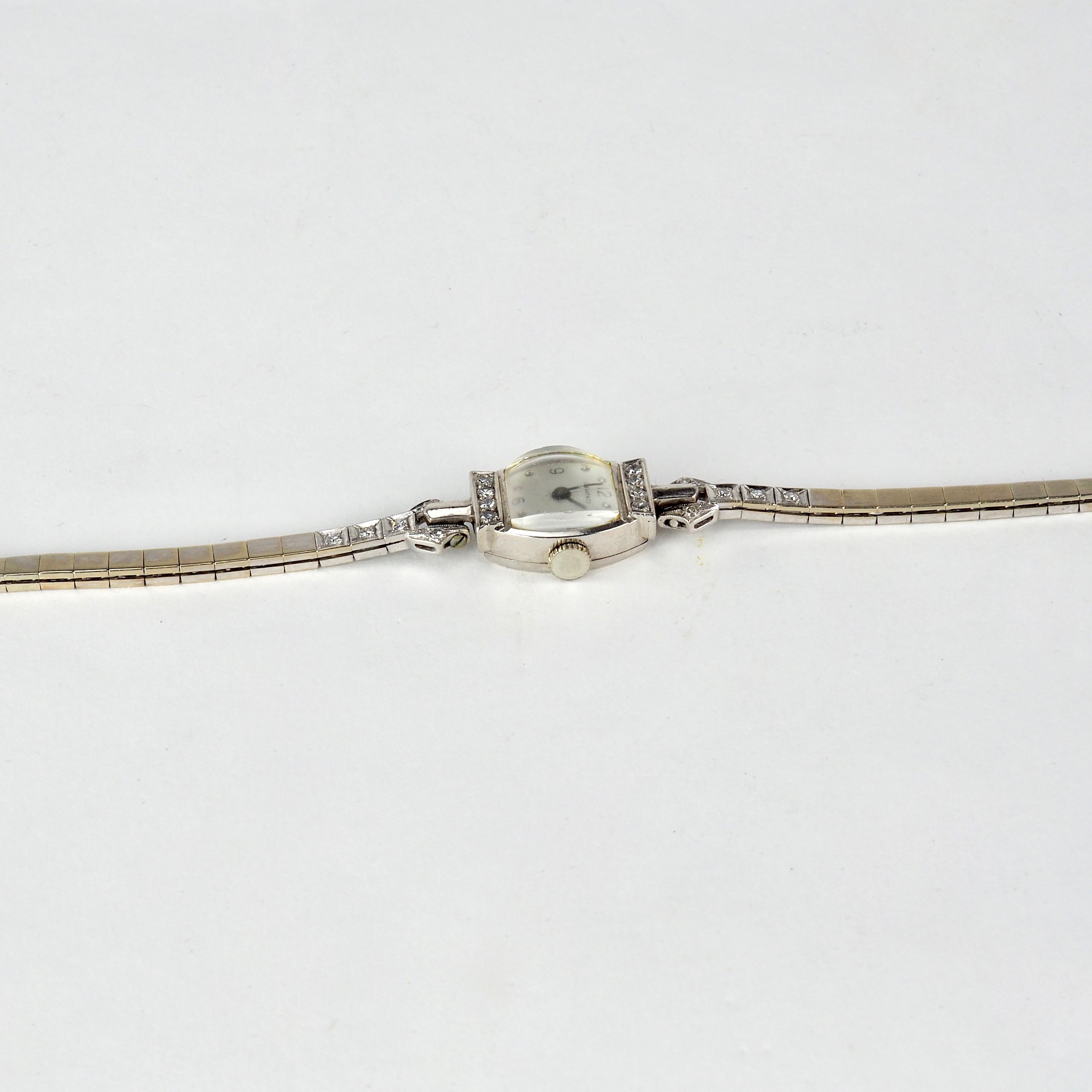 Tiffany 14k gold ladies wristwatch set with 18 rose cut diamonds to case and strap with a Palladium back. Stamped Movado Factories, Swiss Made.  Made by Movado Watch Co. for Tiffany & Co., manually wound, 17 jewels, cut-bimetallic balance, index