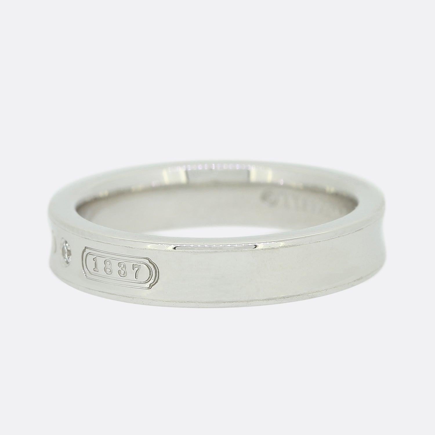 This is an 18ct white gold, diamond ring from the luxury jewellery designer Tiffany & Co. The face of the ring features an inscription of '750' for 18ct gold, 'T&Co' and '1837' the year in which Tiffany was founded.

Condition: Used (Very
