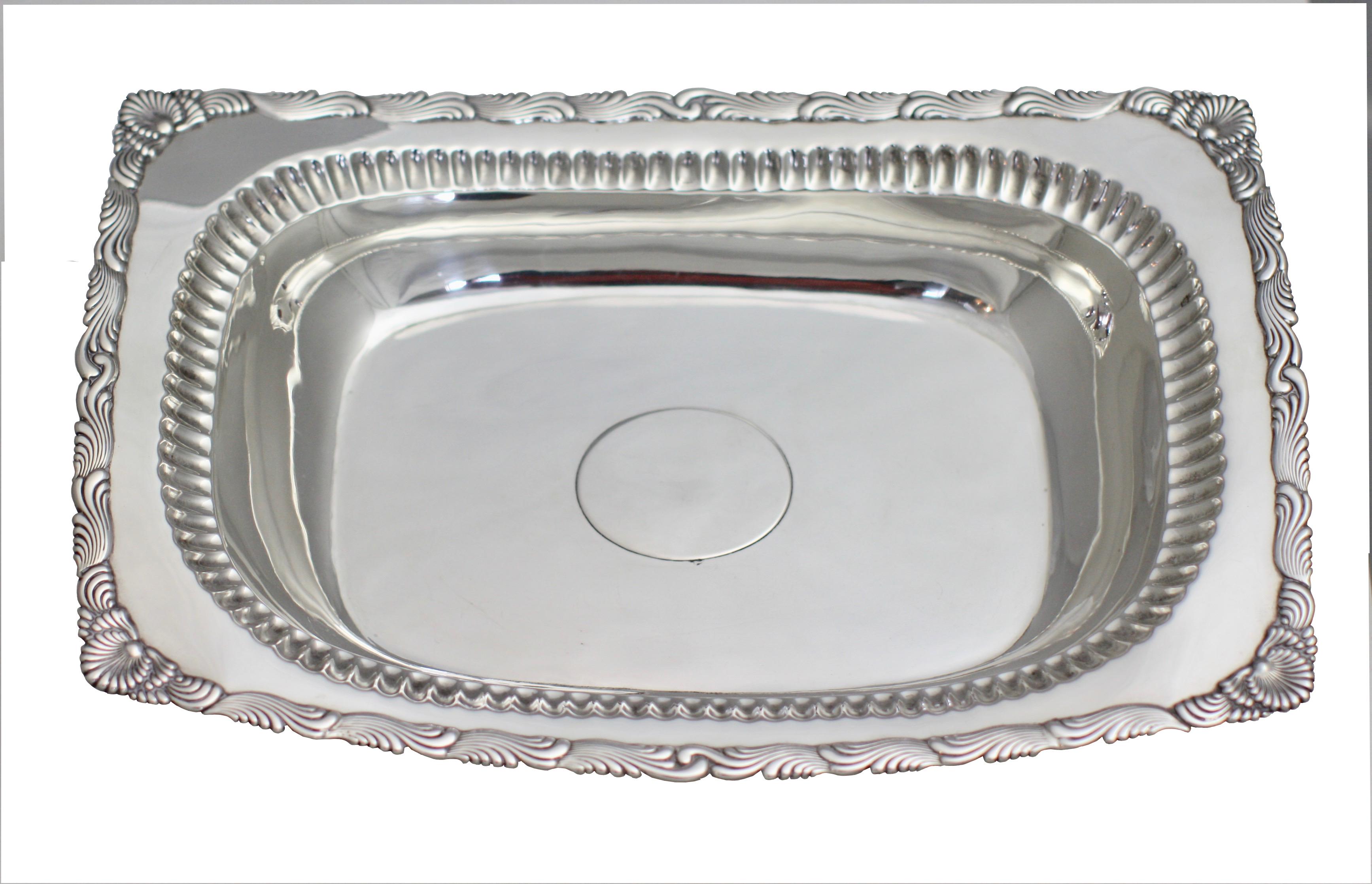 Tiffany (1891-1902) sterling silver serving bowl
Rectangular form with a shell corner and a wavy edge outer border and a secondary fluted edge at the top of bowl.
Measures: Length 11 1/2 in. (29.21 cm.)
Weighing approximately 19