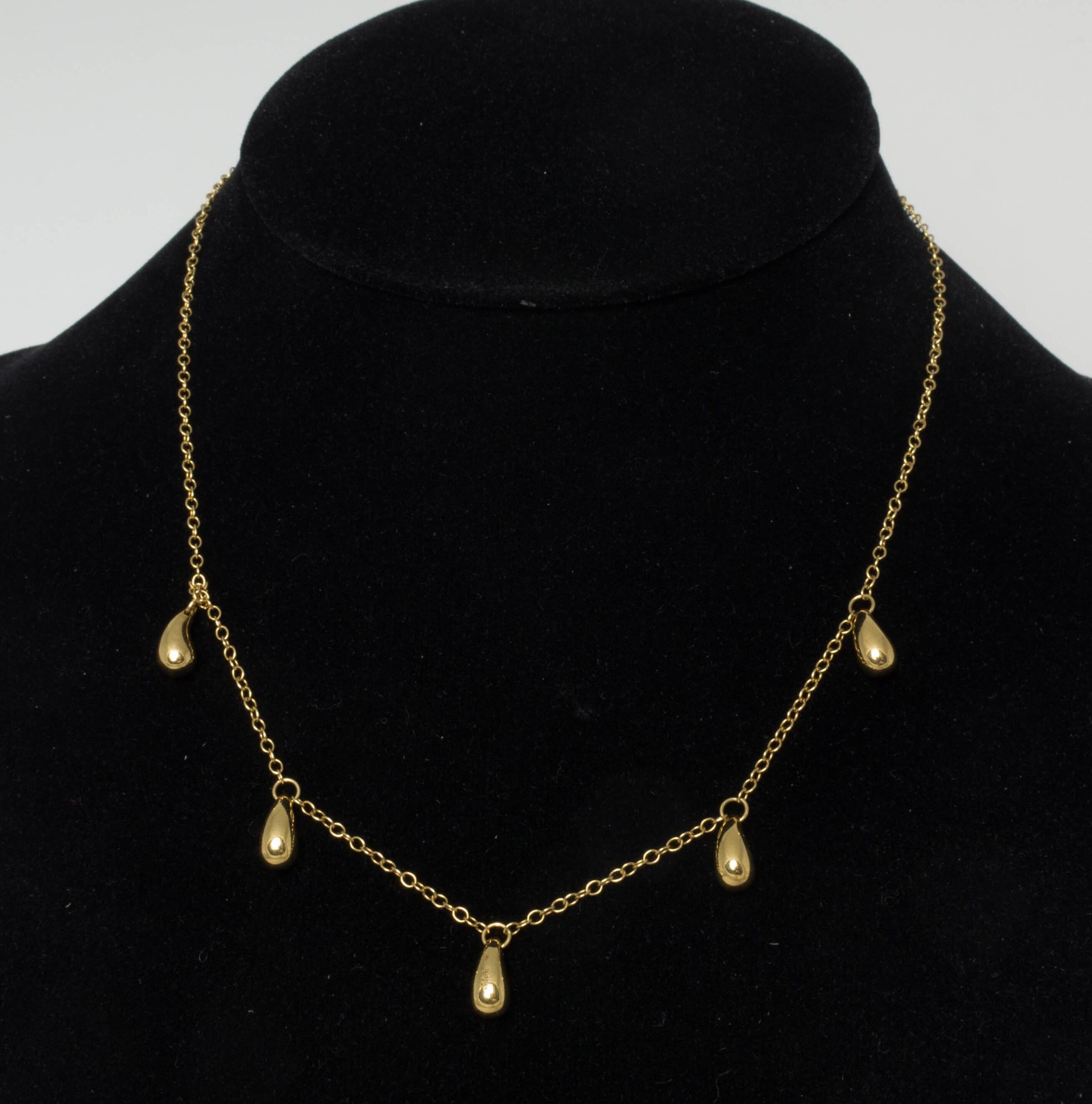 Rare five pendants 18K yellow gold Elsa Peretti iconic tear drop design necklace by Tiffany & Co.  Necklace is 16.25 inches long. 5 Pendants are measured 3/8 inches long each. Total weight of necklace is 9.9 grams. Signed Tiffany & Co, Peretti, 750.