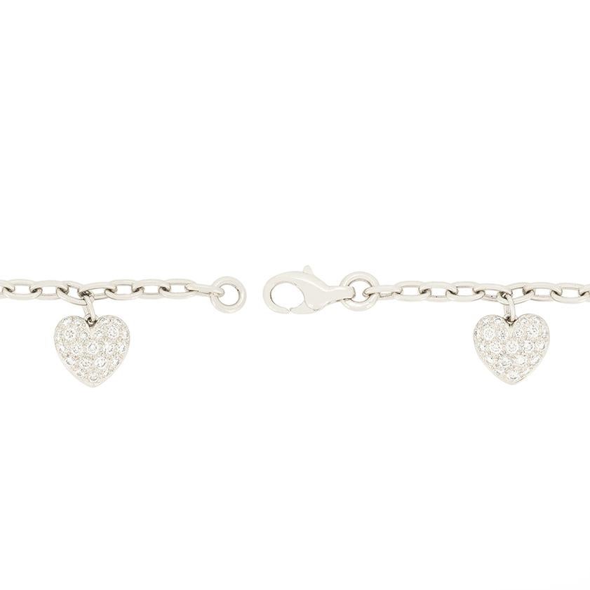 This Heart Charm Bracelet from the designer Tiffany & Co. is Excuisite. Crafted in platinum, it features four hearts adorned with dazzling pavé-set diamonds, accompanied by a delicate open heart embellished with a row of diamonds at its centre. The