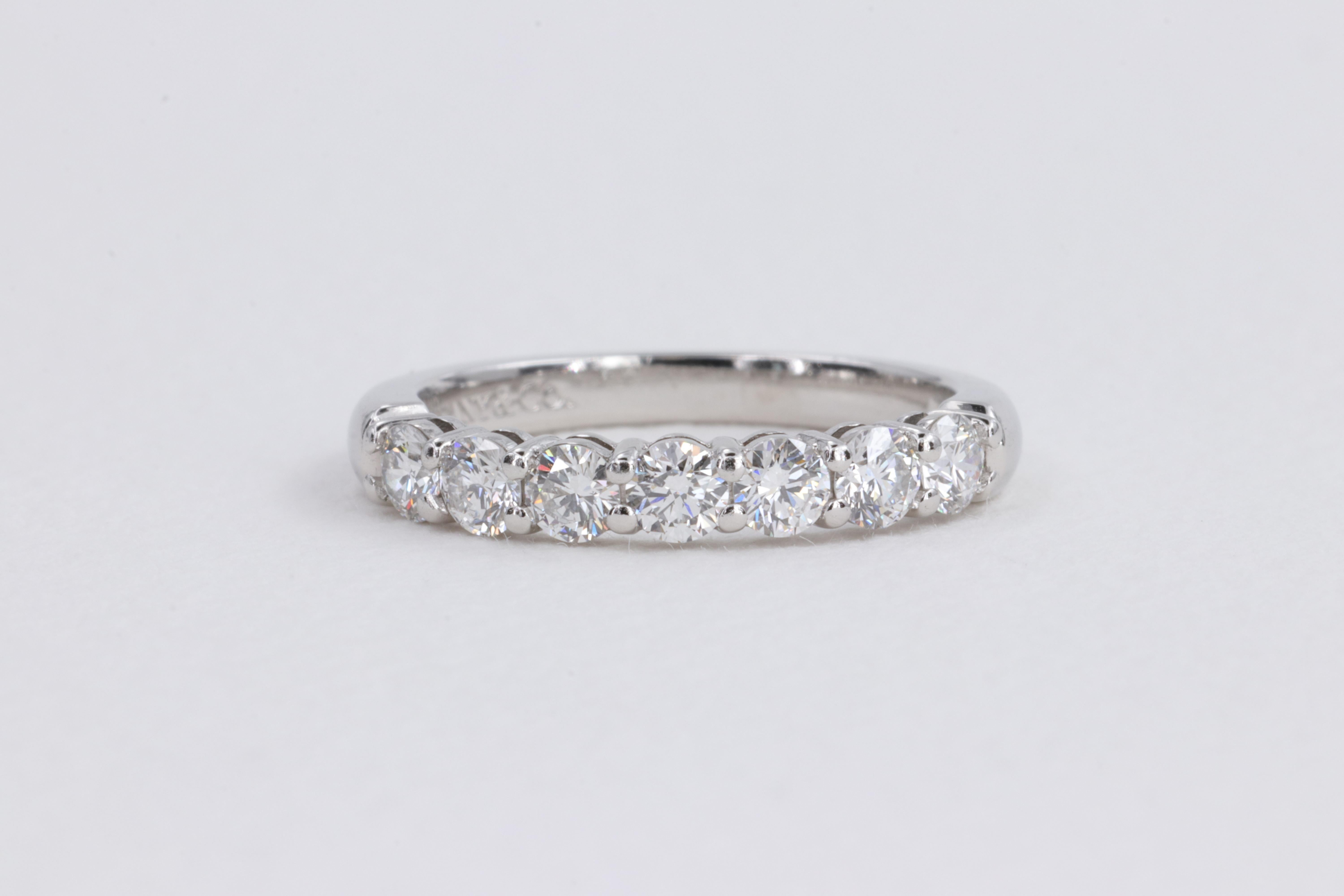 Tiffany & Co. Embrace 7 Stone Diamond Wedding Anniversary Band with .57cttw round brilliant cut diamonds of fine quality set half way around in platinum.

Finger size 4.5 US