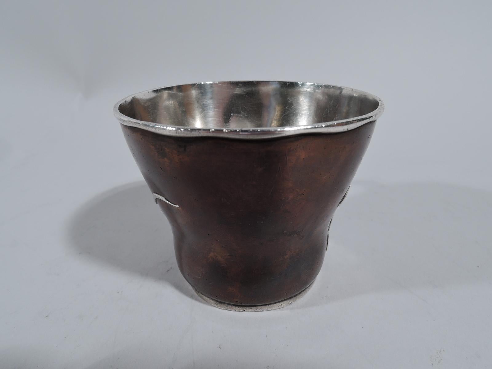 Aesthetic Japonesque mixed metal christening mug. Made by Tiffany & Co. in New York, circa 1879. Tapering copper body applied with silver tendril and leaf. Silver scroll handle, foot ring, and wavy rim. Interior also silver with visible handwork.