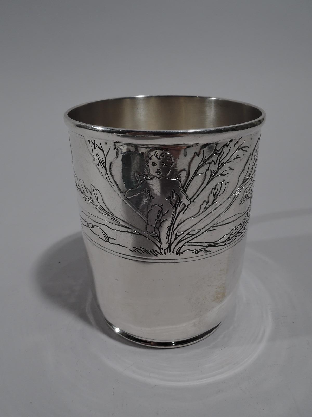Art Nouveau sterling silver baby cup. Made by Tiffany & Co. in New York, circa 1910. Straight sides, short inset foot, and C-scroll handle. Slightly hallucinatory acid-etched frieze with cherubs frolicking amidst aquatic foliage and giant mushrooms.