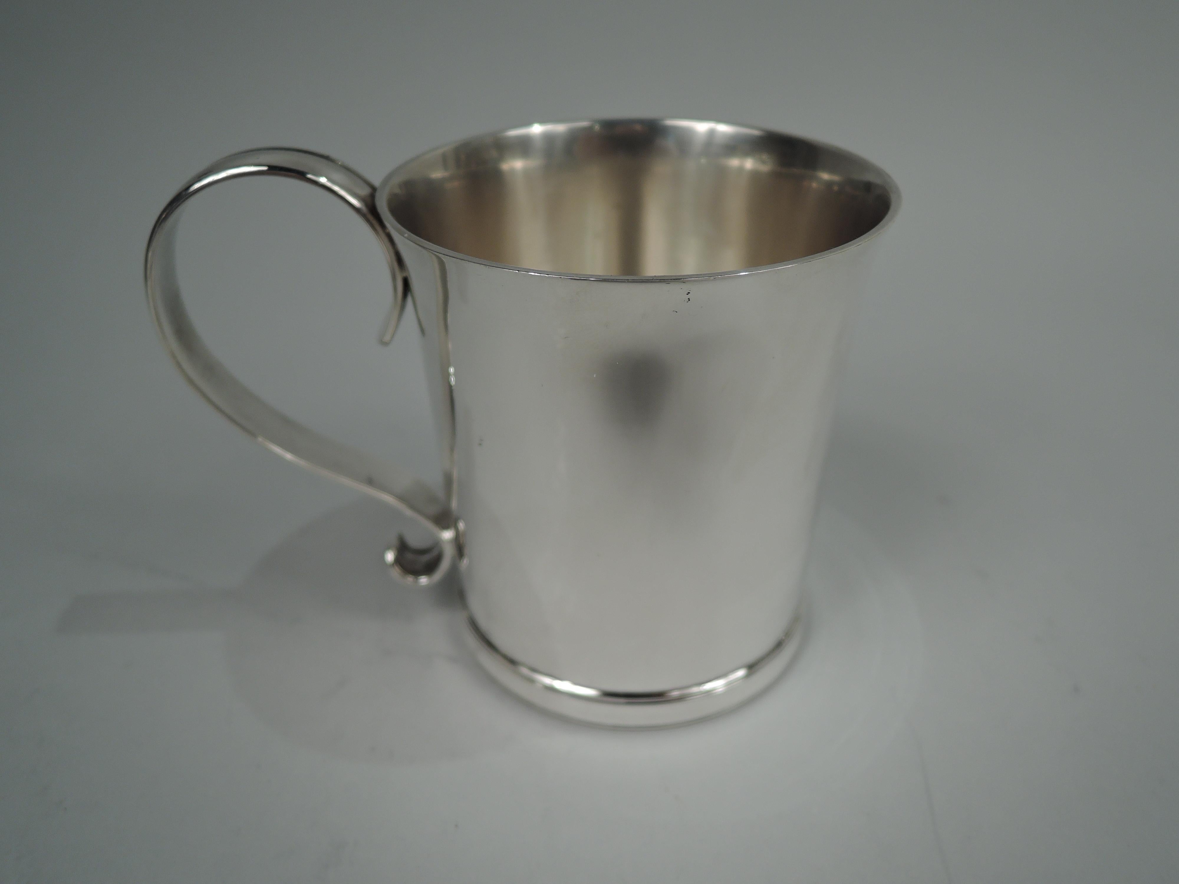 Colonial Revival sterling silver baby cup. Made by Tiffany & Co. in New York. Straight sides with gently flared rim, s-scroll handle and molded base. Lots of room for engraving. Fully marked including maker’s stamp, pattern no. 19184, and director’s