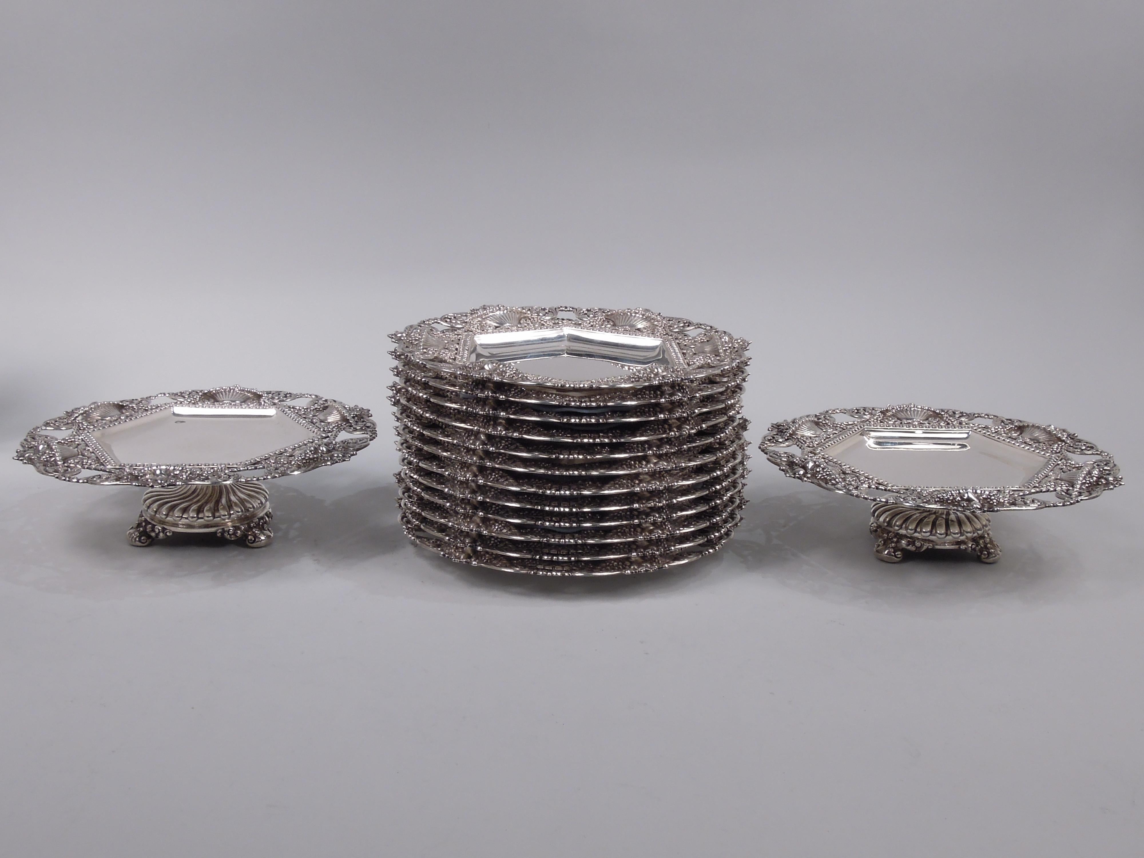 Turn-of-the-century sterling silver dessert set with world’s fair exhibition history. Made by Tiffany & Co. in New York. This set comprises 12 plates and 2 compotes. Each plate: Hexagonal well bordered by bead-and-reel surrounded by applied and open