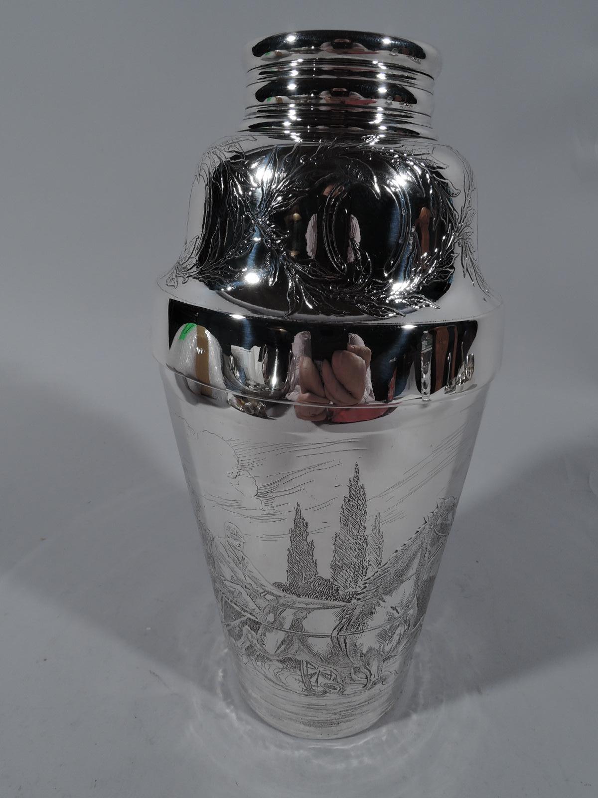 Edwardian sterling silver cocktail shaker. Made by Tiffany & Co. in New York. Tapering cup and detachable domed top with twist spout. Acid-etched ornament: On cup a carriage race between two sulkies (one-person vehicles). On top interlaced branches