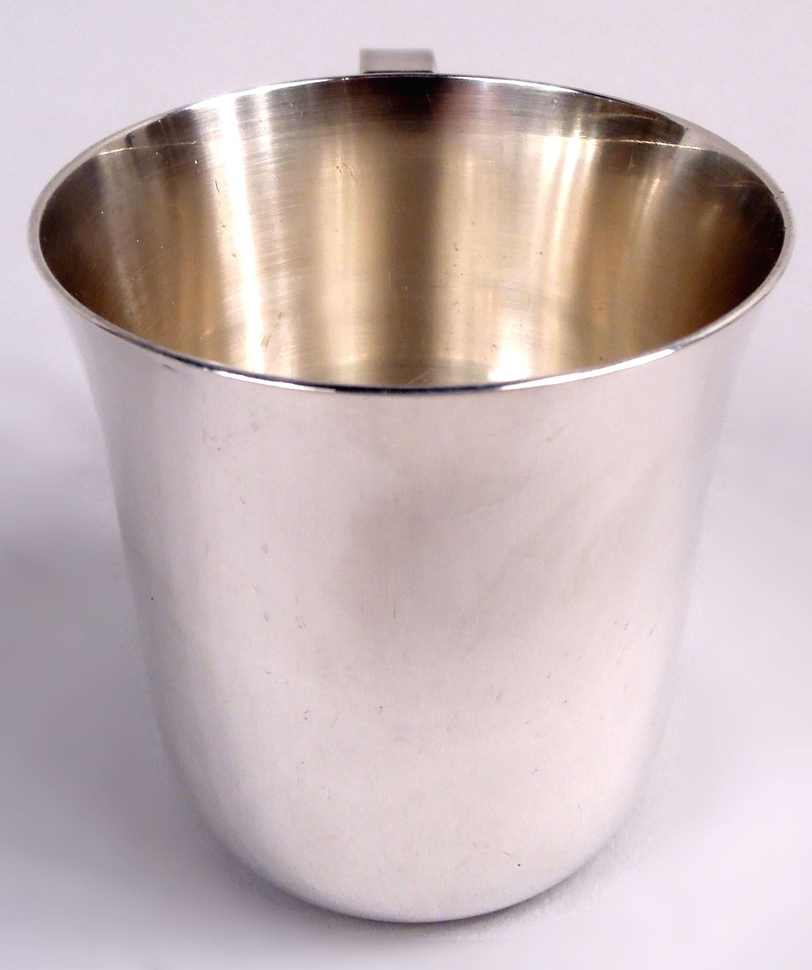 Midcentury Modern sterling silver baby cup. Made by Tiffany & Co. in New York. Plain with flared rim and looping handle. Lots of room for engraving. Fully marked including maker’s stamp and pattern no. 23245 (first produced in 1947). Weight: 3.7