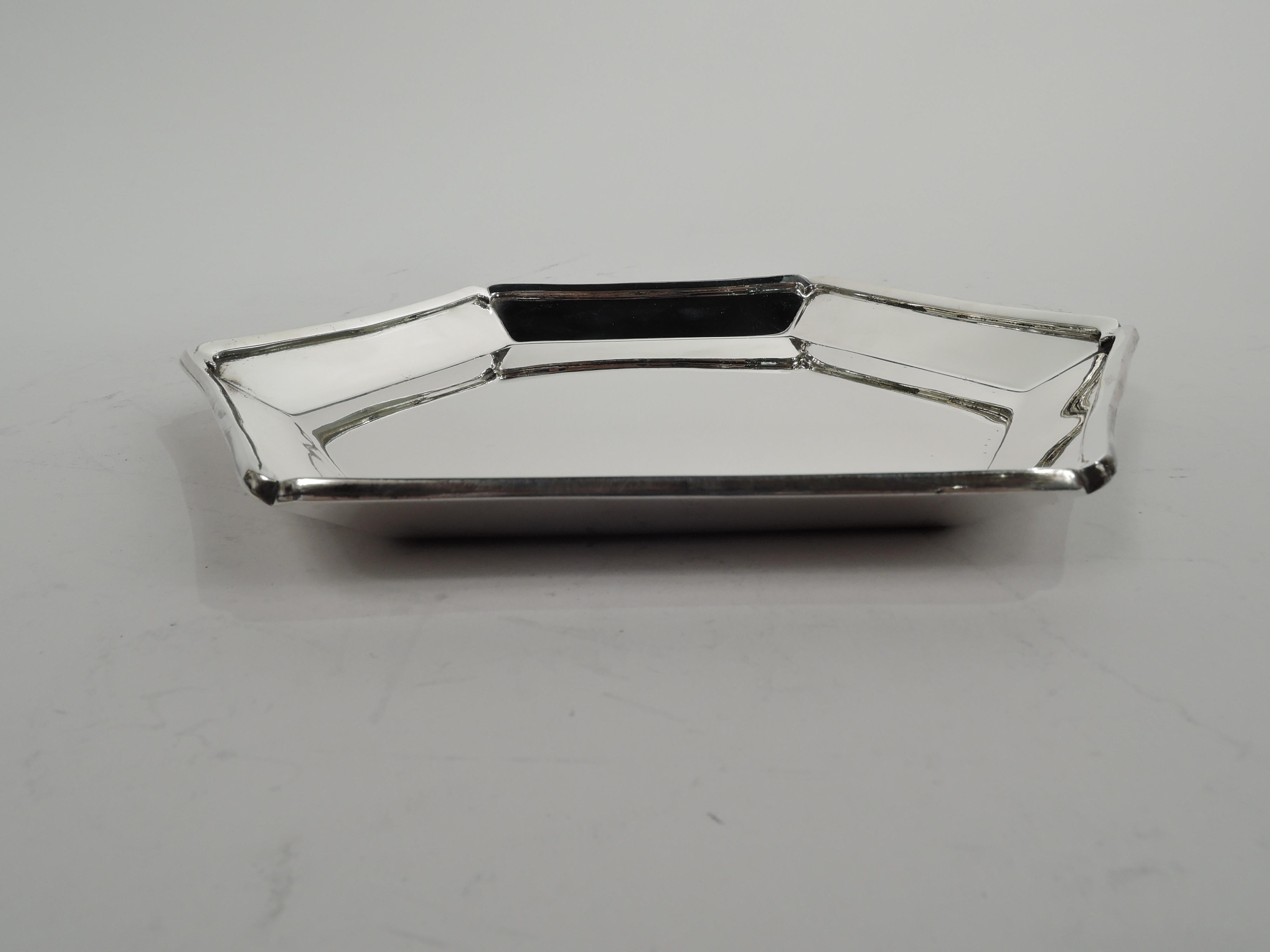 Mid-Century Modern sterling silver tray. Made by Tiffany & Co. in New York. Octagonal well Sides tapering with applied interior rim terminating in corner scrolls. Fully marked including maker’s stamp and postwar pattern no. 25409. Heavy weight: 16
