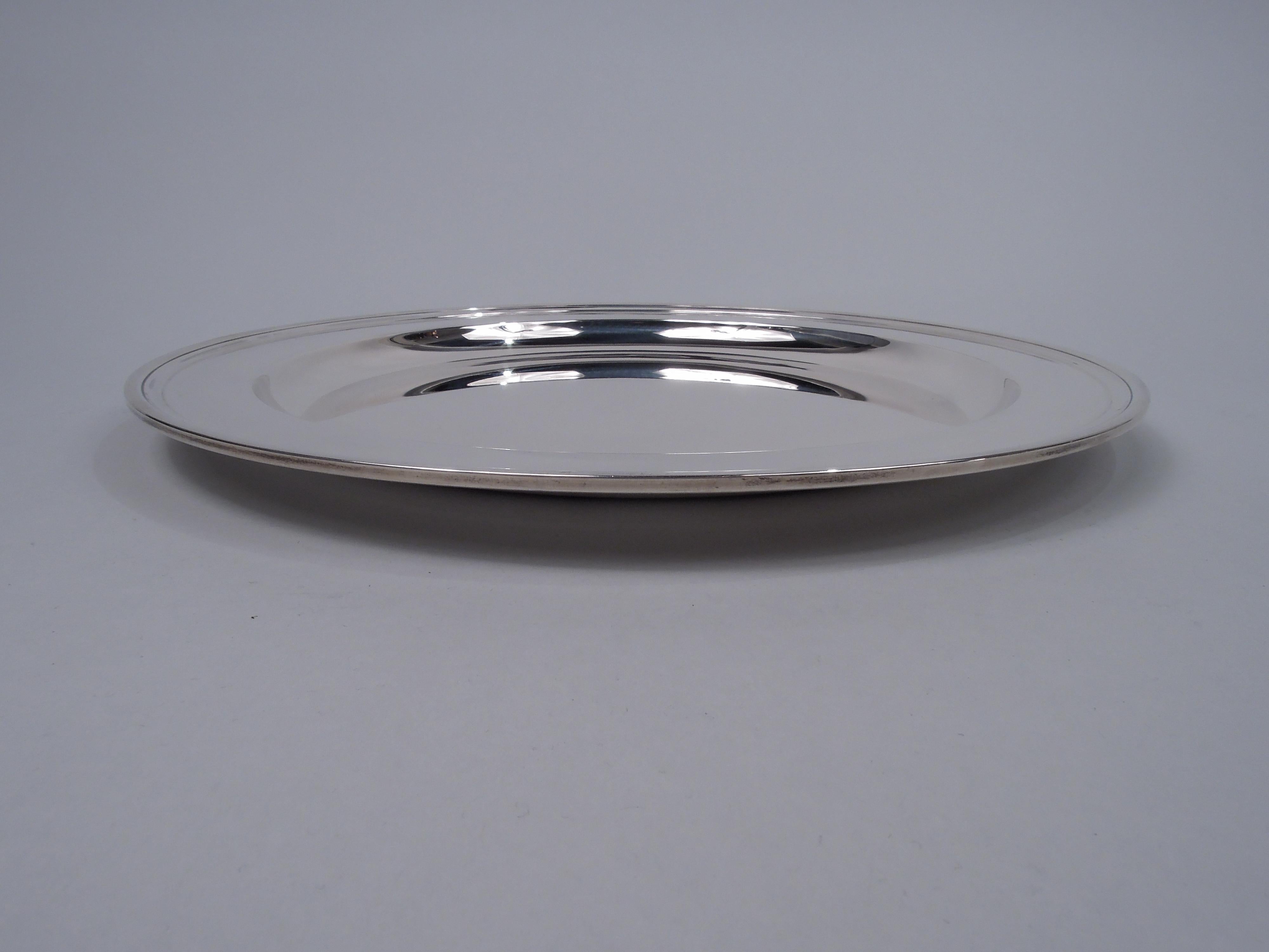 Modern sterling silver tray. Made by Tiffany & Co. in New York. Deep well, wide shoulder, and flat rim. Fully marked including maker’s stamp, pattern no. 20188, and director's letter L (1956-ca 1965). Heavy weight: 28.5 troy ounces.  