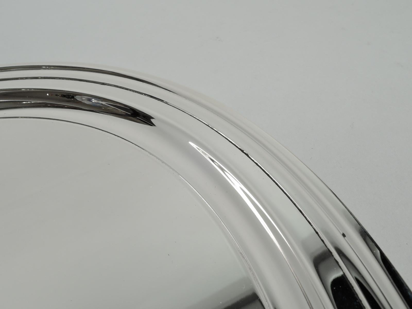 Modern sterling silver tray. Made by Tiffany & Co. in New York. Round with molded rim. Fully marked including maker’s stamp and postwar pattern no. 25212. Weight: 17 troy ounces. Measure: 10 inch.