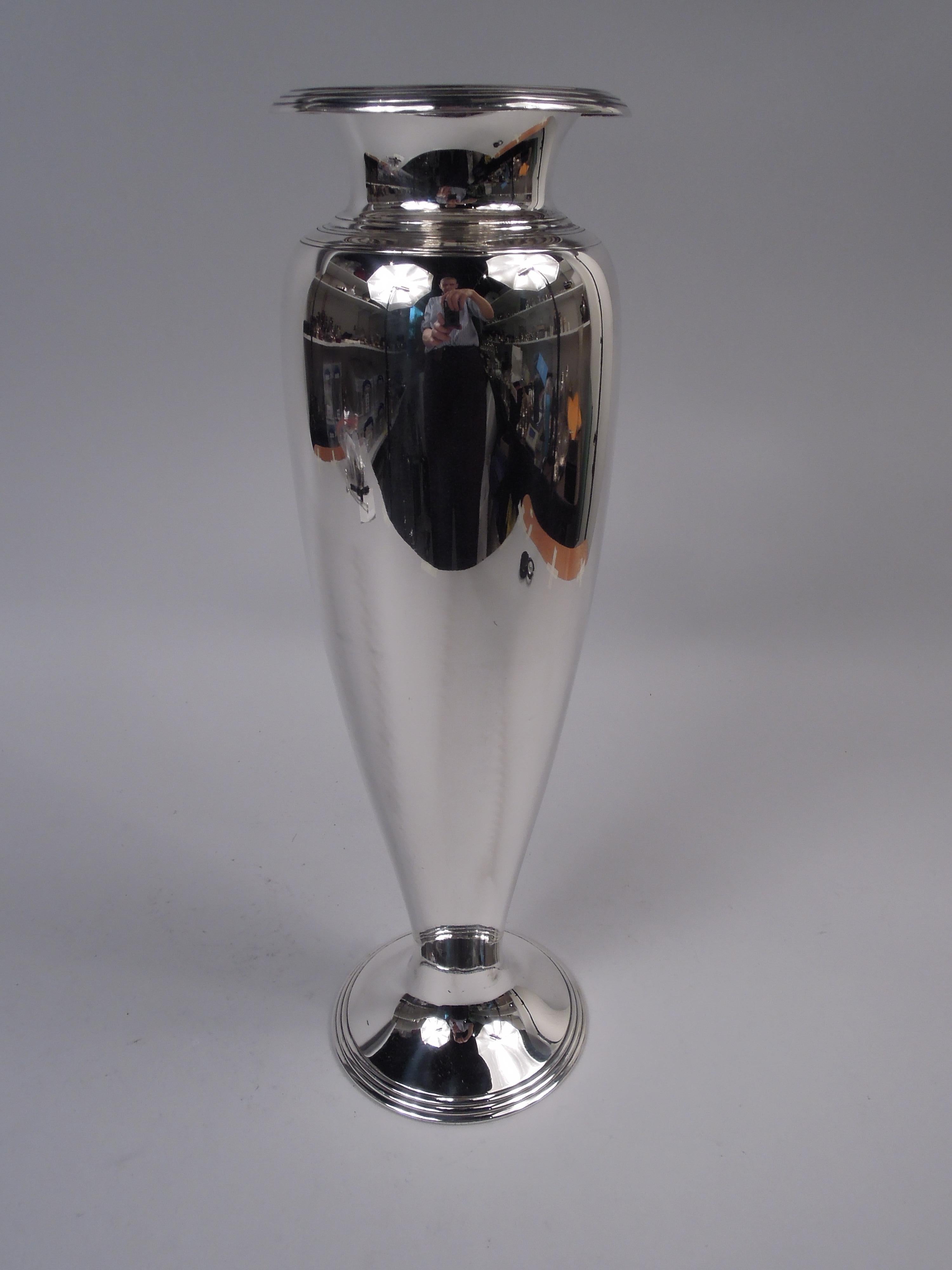 Modern sterling silver vase. Made by Tiffany & Co. in New York, ca 1908. Tall and tapering ovoid bowl; concave neck and turned-down rim and raised foot. Reeded rims and shoulder. Fully marked including maker’s stamp, pattern no. 17106A (first