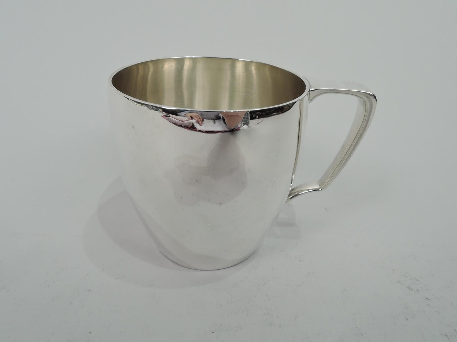 Modern sterling silver baby cup. Made by Tiffany & Co. in New York. Barrel-form with scroll bracket handle. Elegant form with plenty of room for engraving. Fully marked including maker’s stamp, pattern no. 20850, and director’s letter M (1947-56).