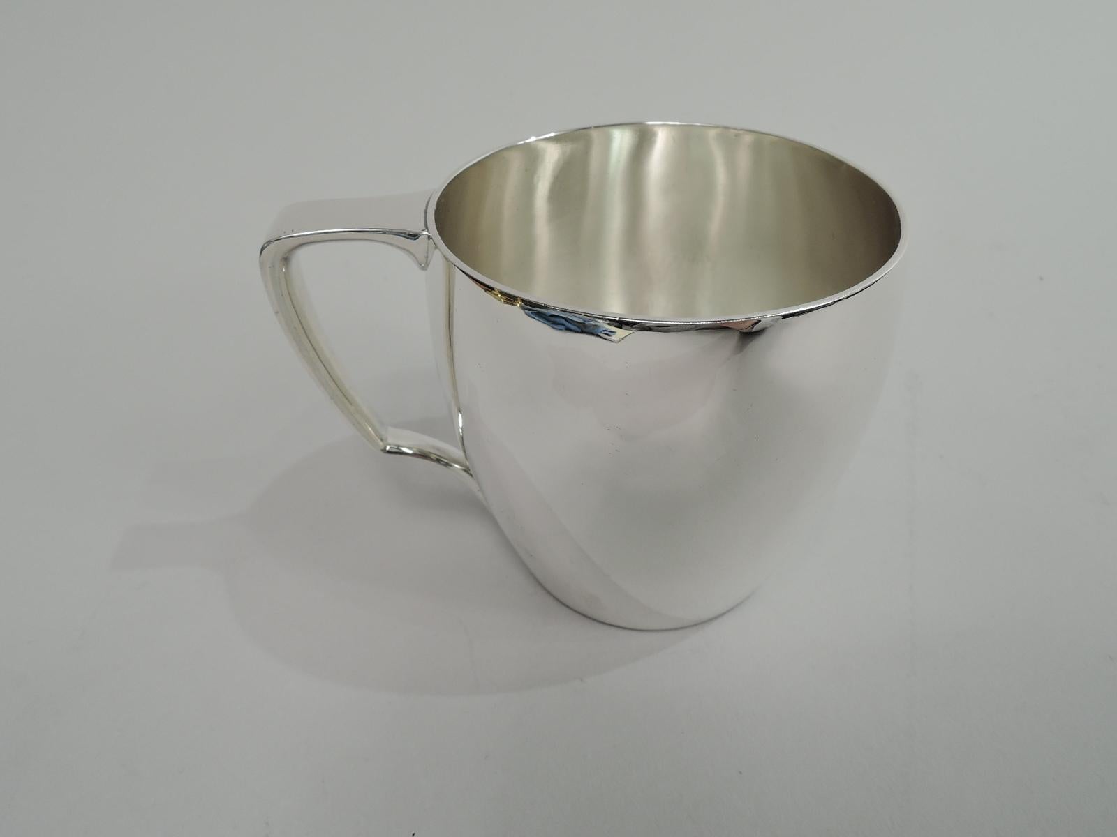 Modern sterling silver baby cup. Made by Tiffany & Co. in New York. Barrel-form with scroll bracket handle. Elegant form with plenty of room for engraving. Fully marked including maker’s stamp, pattern no. 20850, and director’s letter M (1947-56).