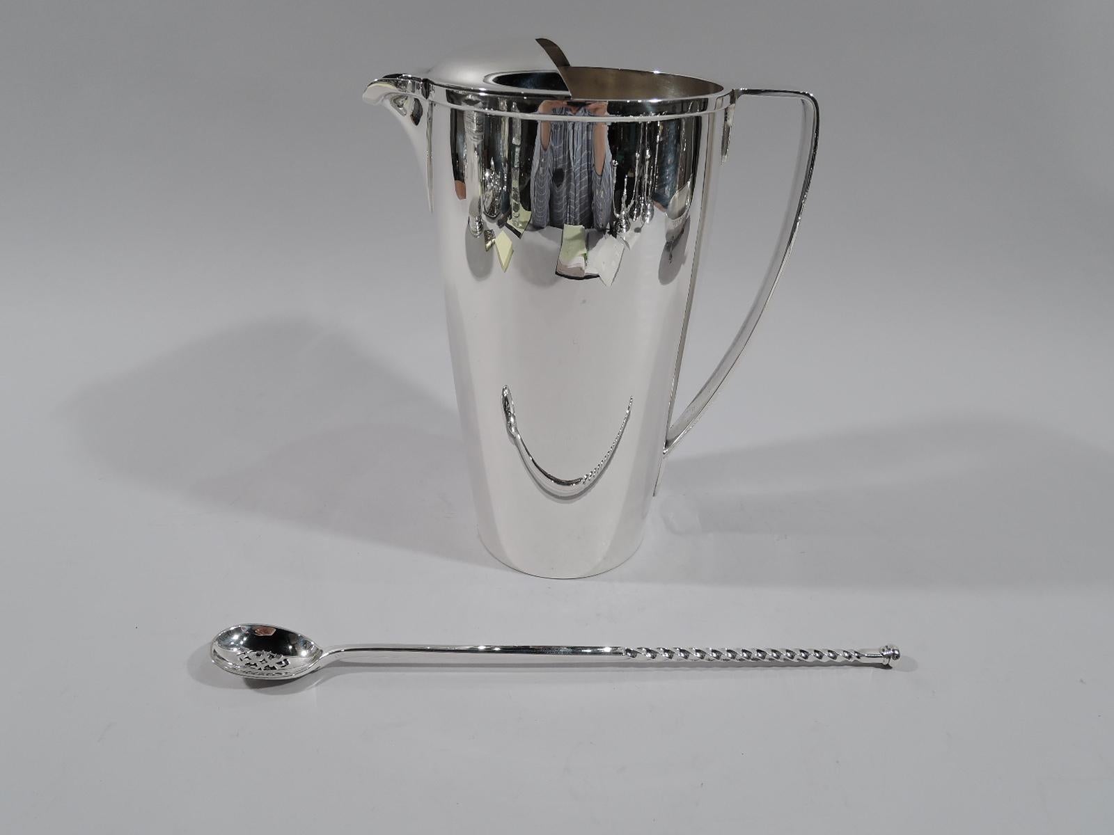American modern sterling silver bar pitcher. Made by Tiffany & Co. in New York, circa 1933. Tapering sides, scroll bracket handle. Spout U-form with built in strainer and raised ice guard. Super stylish with nice heft. Fully marked including pattern