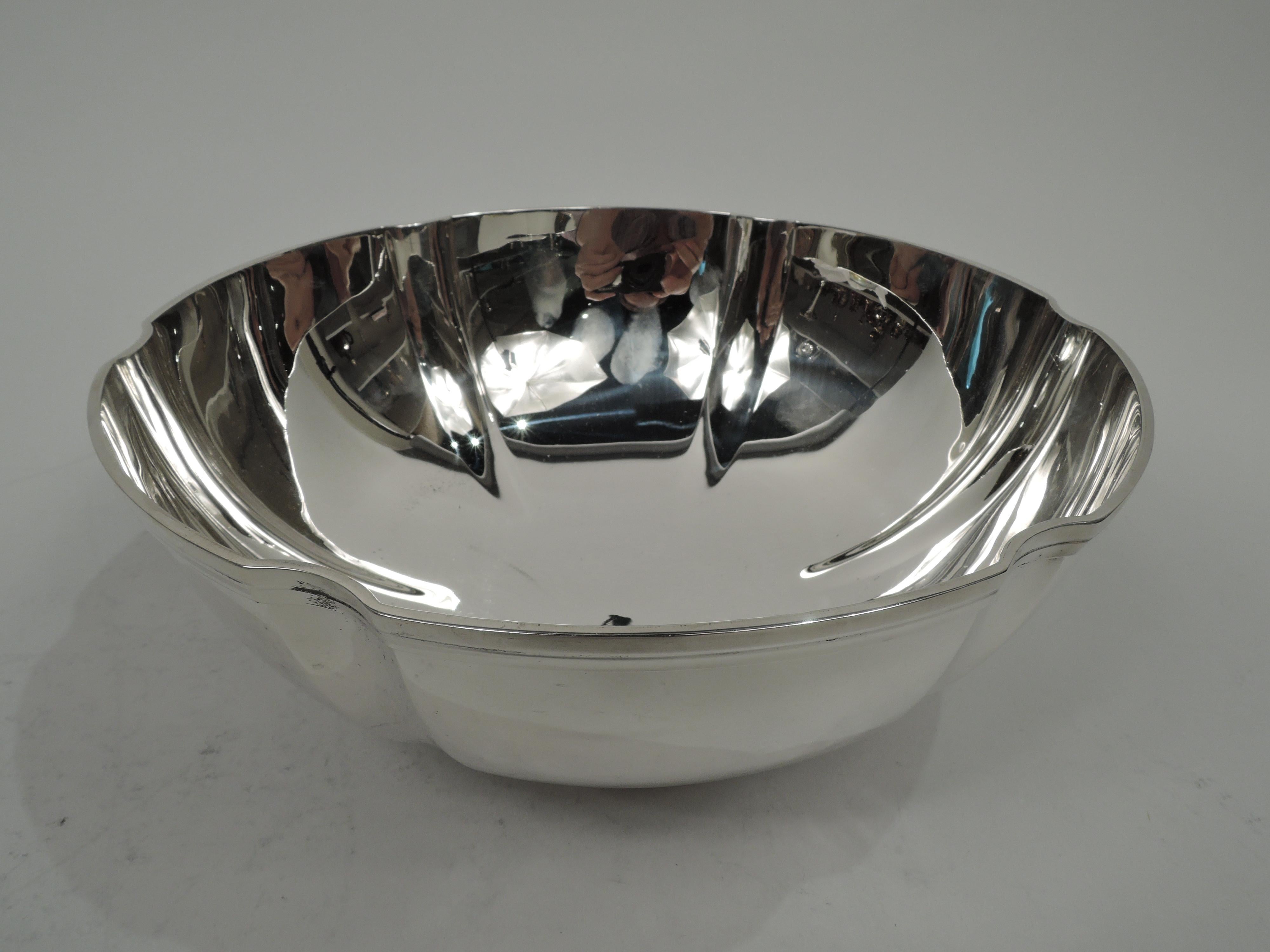 Modern sterling silver bowl. Made by Tiffany & Co. in New York, ca 1937. Round with curved and fluted sides. Rim flat and applied with incised band. Short foot ring with same. Fully marked including maker’s stamp, pattern no. 22392 (first produced