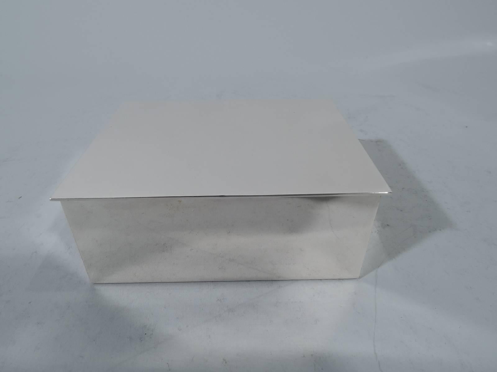 Modern sterling silver desk box. Made by Tiffany & Co. in New York. Rectangular with straight sides and sharp corners. Cover hinged and flat with minor overhang. Box interior cedar lined. Hallmark includes postwar pattern no. 23325. Gross weight: