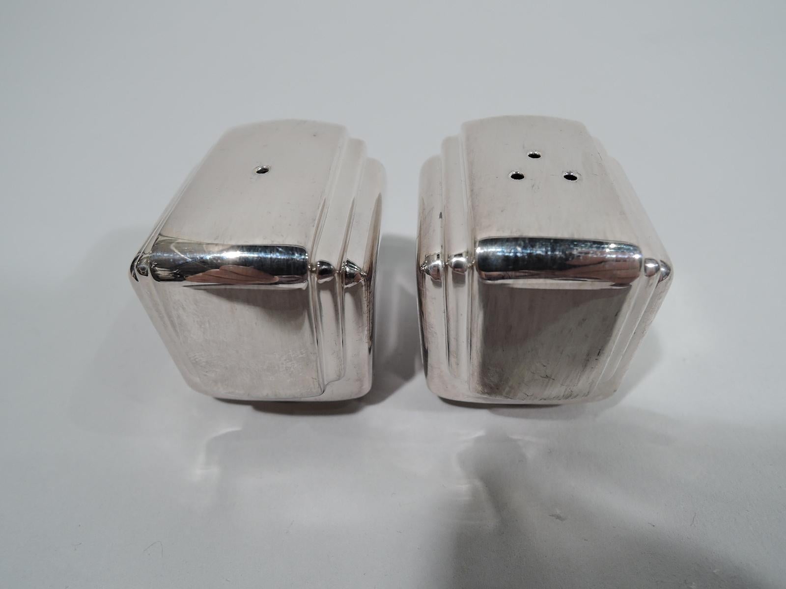 American Modern sterling silver salt and pepper shakers. Retailed by Tiffany & Co. in New York. Each: Rectangular with stepped sides and round and threaded foot. Marked “925” with retailer’s stamp. Total weight: 3 troy ounces.