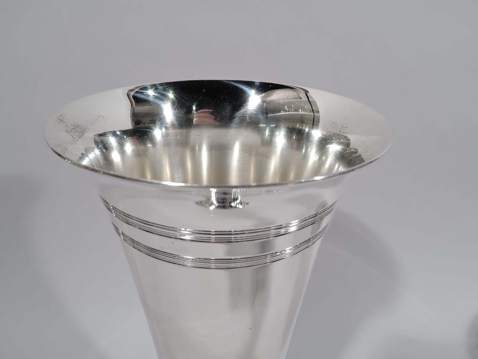Modern sterling silver vase. Made by Tiffany & Co. in New York, circa 1910. Conical with flared rim, short upward tapering, and round stepped foot. Engraved reeded bands at top and foot. Fully marked including pattern no. 17040 and director’s letter