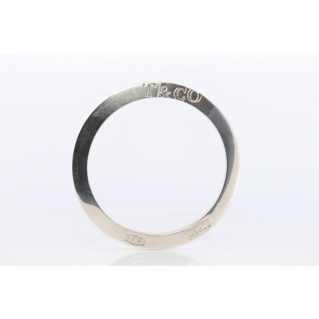 Vintage By aus den 1980er Jahren

MATERIALIEN: Silber

Authentisches gebrauchtes Tiffany-Armband. RARE 1837 Flache Scheibe Armreif.

7 mm breit
35,8 Gramm
61 mm Innendurchmesser.