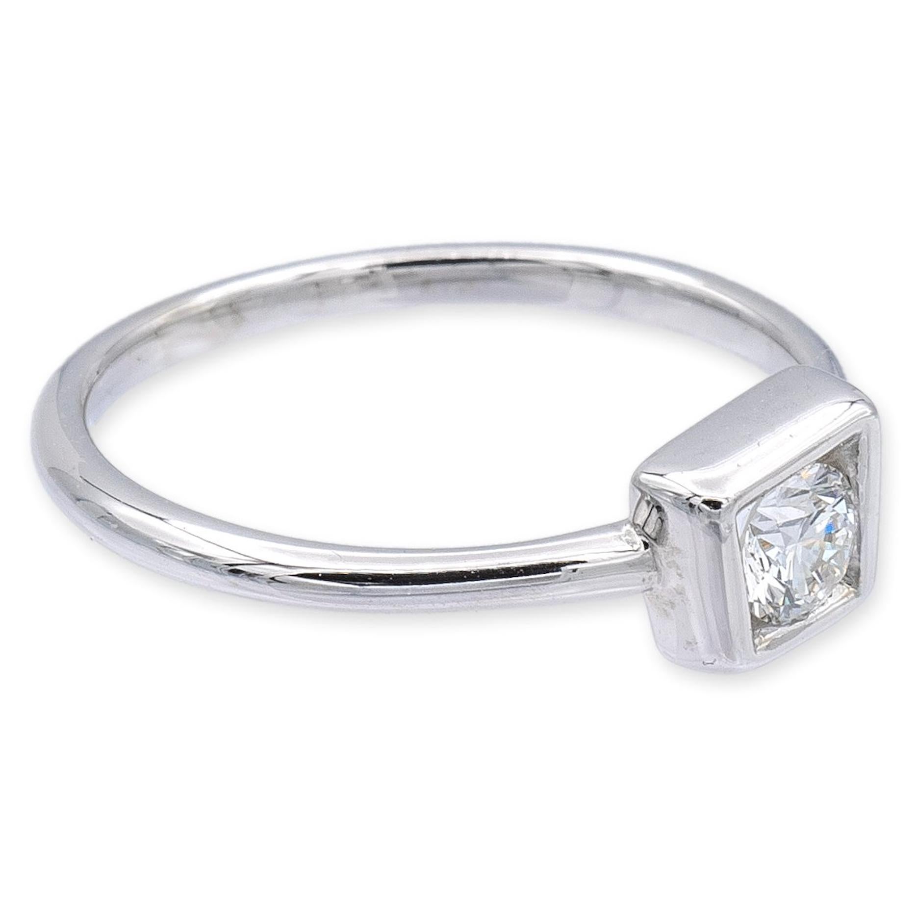 Tiffany & Co limited edition signature ring by Frank Gehry finely crafted in 18 karat white gold featuring a round brilliant cut 0.20 center E color VS1 clarity set inside a minimalist style square bezel. Square measures 5mm approximately. Fully