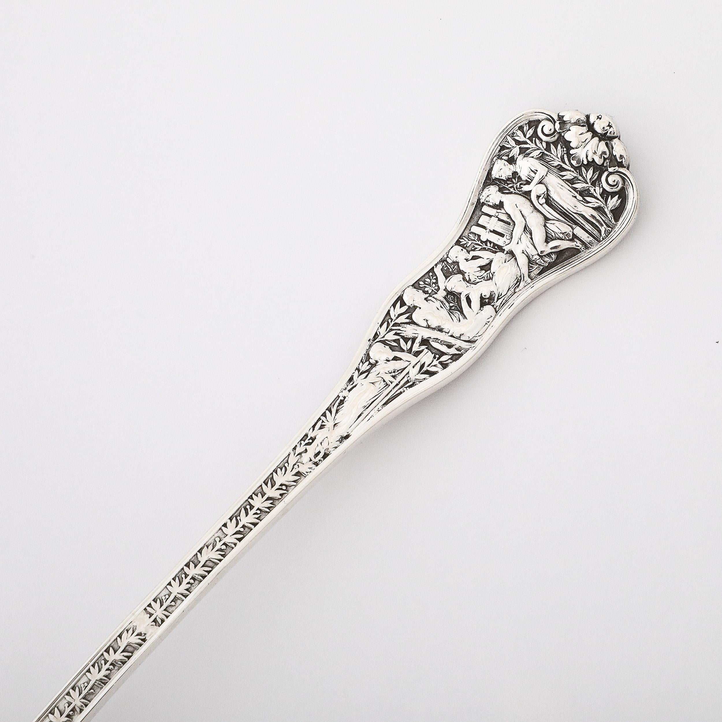 This rare and stunning Tiffany and Co. 19th Century Sterling Silver and Gold Washed Serving Spoon in Olympian Pattern originates from the United States in 1878. Features a gold washed rounded rectangular scoop, with an illustrious and highly