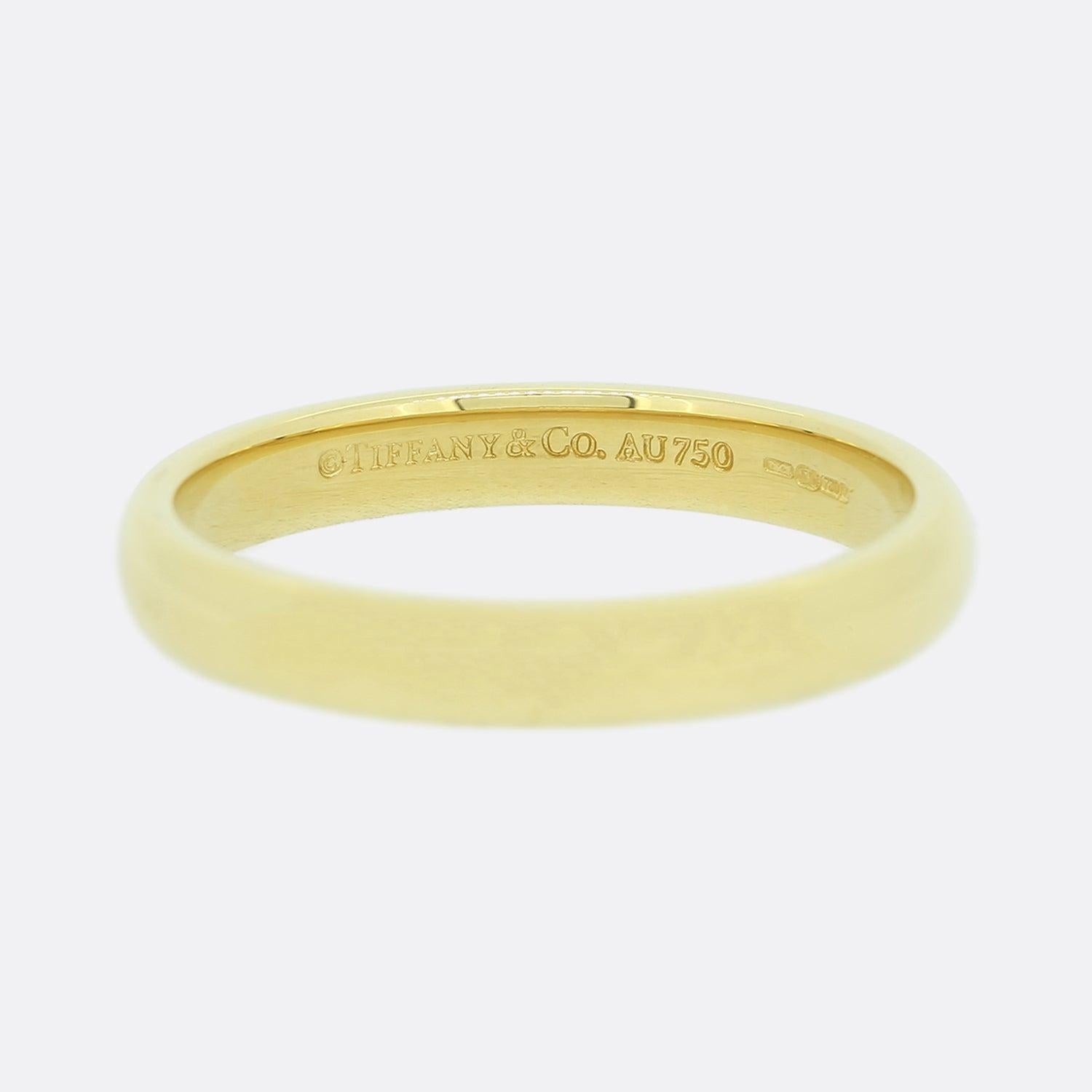 This is a classic unembellished Tiffany & Co. 18ct yellow gold 3mm wedding band ring.

Condition: Used (Very Good)
Weight: 3.3 grams
Ring Size: M (53)
Band Width: 3mm
Marked: 'Tiffany & Co' '750'
Period: Modern 
Box: The Vintage Jeweller Ring Box