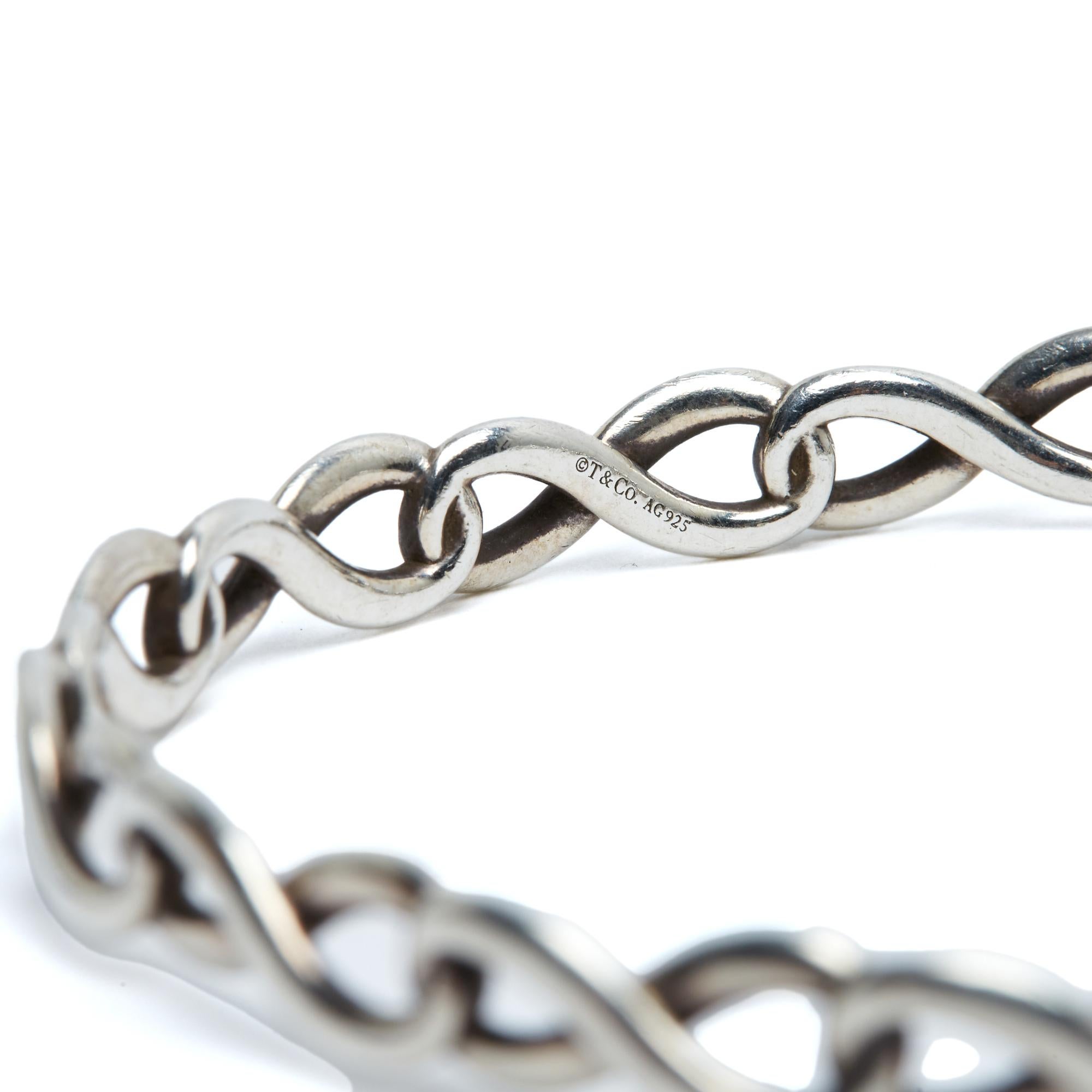 Tiffany & Co. Bracciale rigido Infinity in argento 925/1000, diametro interno 6,2 cm (per un polso di circa 15,5 cm), peso totale 15,03 grammi. Il motivo Infinity è un classico ma questo modello di bracciale è piuttosto raro.