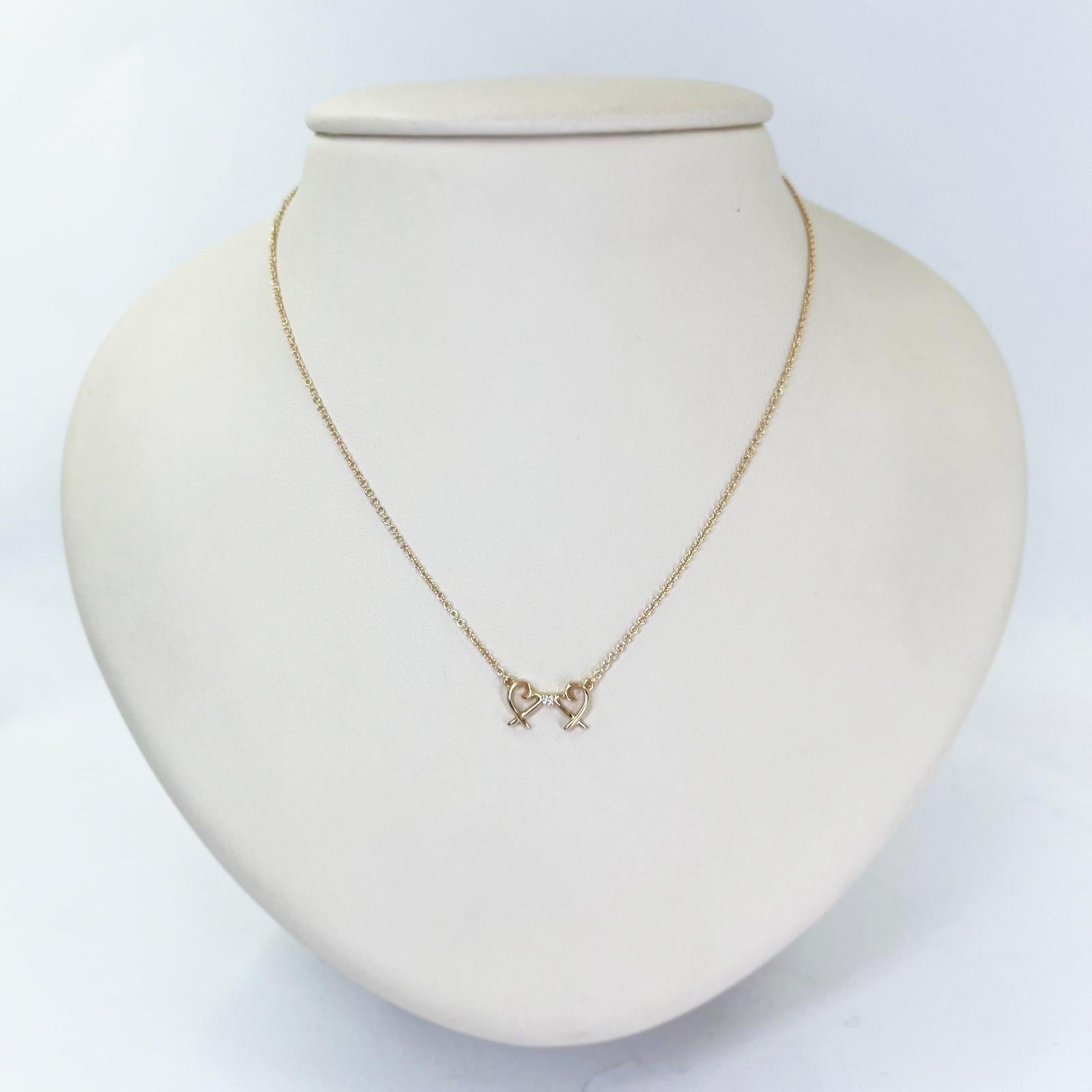 Tiffany and Co. Double Loving Heart necklace crafted in 18 karat rose gold featuring a 0.01 carat round diamond of VS clarity and G color. 16 inch chain with spring ring clasp. Designed by Paloma Picasso. $1,075 MSRP. Includes Tiffany packaging.