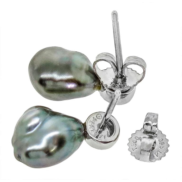This lovely pair of Tiffany & Co. platinum earrings feature Tahitian Keshi black baroque pearls and is set with sparkling round brilliant diamonds that weigh approximately 0.28ct. graded F-G color with VS clarity. The earrings weigh 4.1 grams and