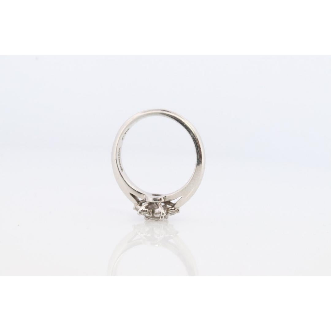 Vintage from the 1990s
Size: 4 US
Materials: Platinum
Gemstone: Diamond
Gem color: Colorless

Band color: Silver

Rare Tiffany and Co. Platinum Diamond Ring.

Hallmarked Tiffany & Co. PT950. Tests appropriately.

Snowflake Flower Diamond
