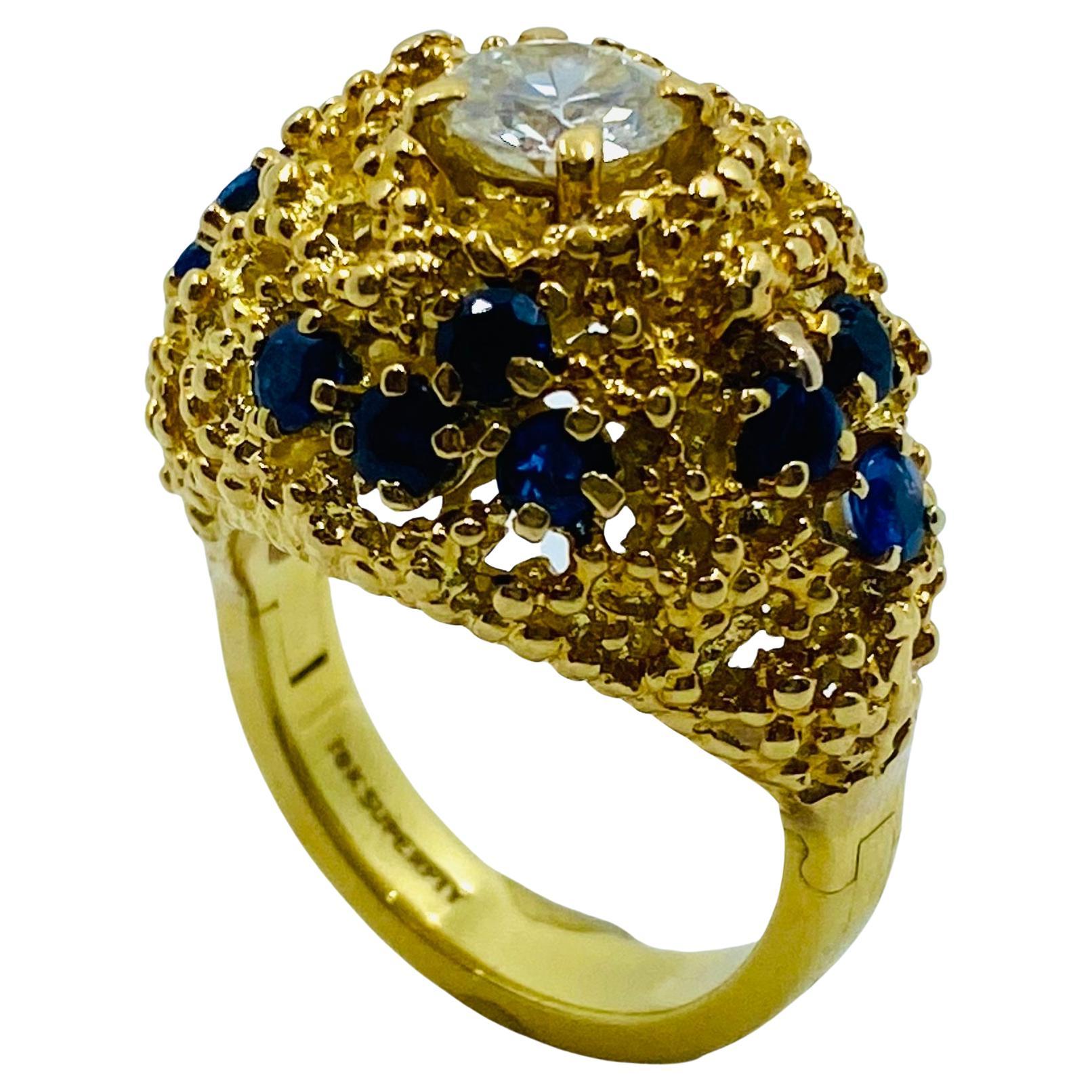 DESIGNER: Tiffany & Co.
CIRCA: 1970’s
MATERIALS: 18k Yellow Gold
GEMSTONE: 0.9 cts.  Round Cut Diamond
GEMSTONE: Sapphire 
WEIGHT: 15.5 grams
MEASUREMENTS: 1 1/4