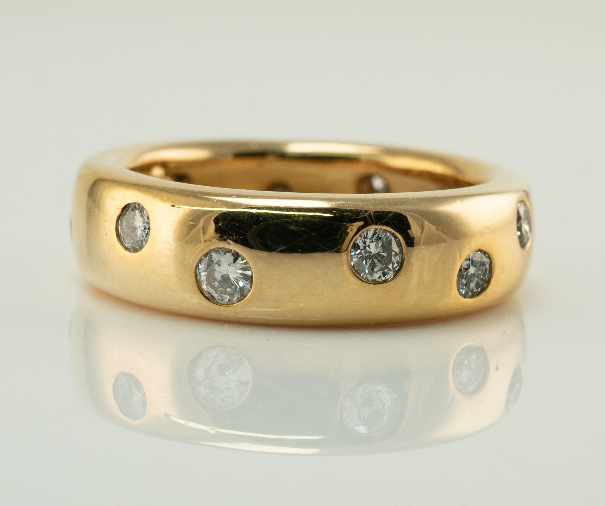 Tiffany and Co Eternity Diamond Ring 1987 18K Gold Wedding Band size about 6.25

This rare estate natural Diamond Eternity ring is finely crafted in solid 18K Yellow Gold by Tiffany and Co.
Twelve round brilliant cut diamonds go all around of the