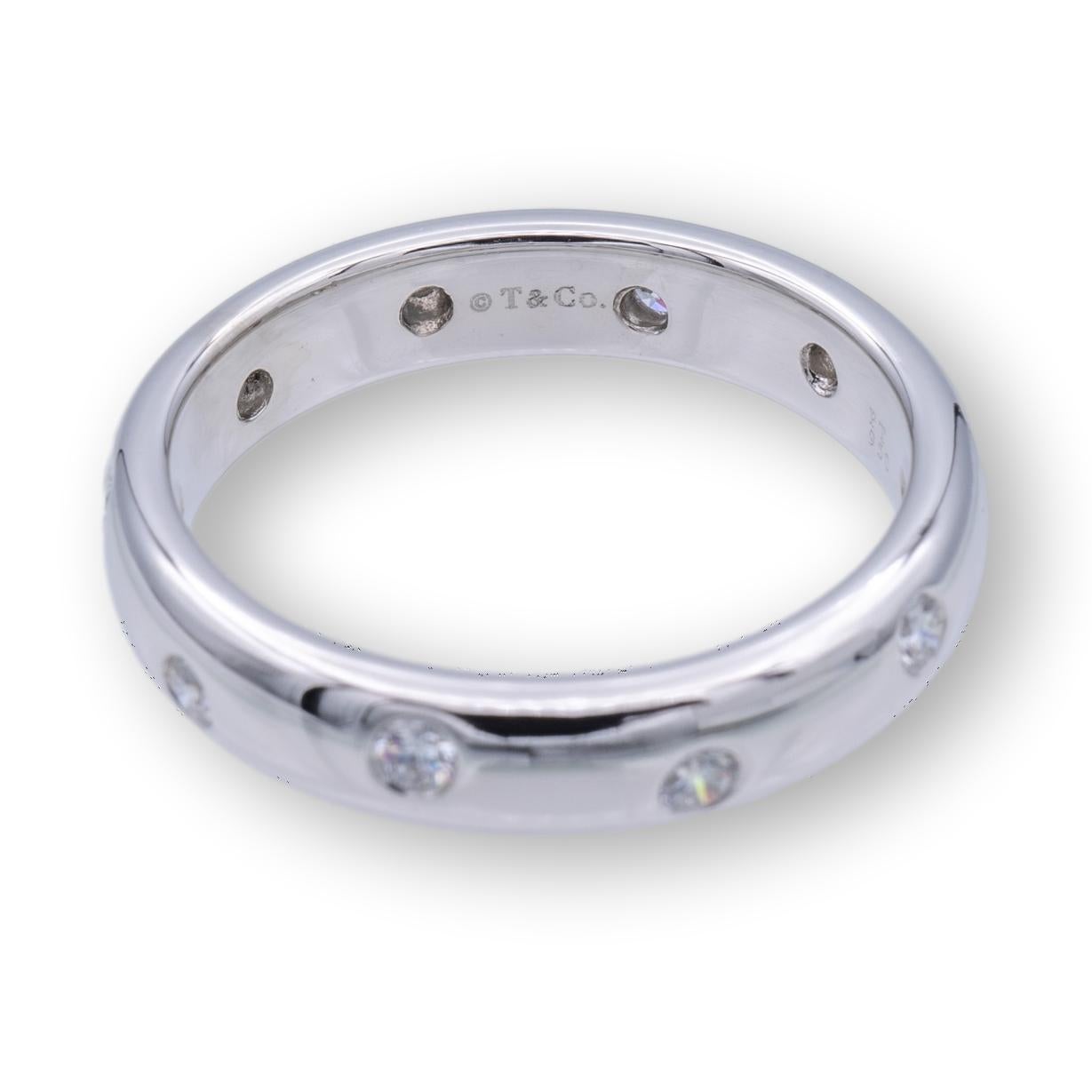 Tiffany & Co. Etoile Domed Band Ring finely crafted in Platinum measuring 3mm wide with 10 round brilliant cut diamonds set in platinum bezels weighing 0.22 carats total weight approximately. The band is domed and comfort fit.

RING