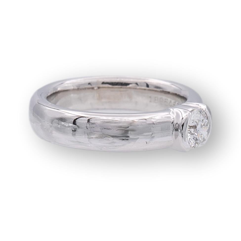 Tiffany and Co. engagement ring from the Etoile collection finely crafted in platinum featuring a round brilliant cut diamond center weighing 0.30 cts. F color , VVS1 clarity set in a half bezel setting. Fully hallmarked with Tiffany logos and metal