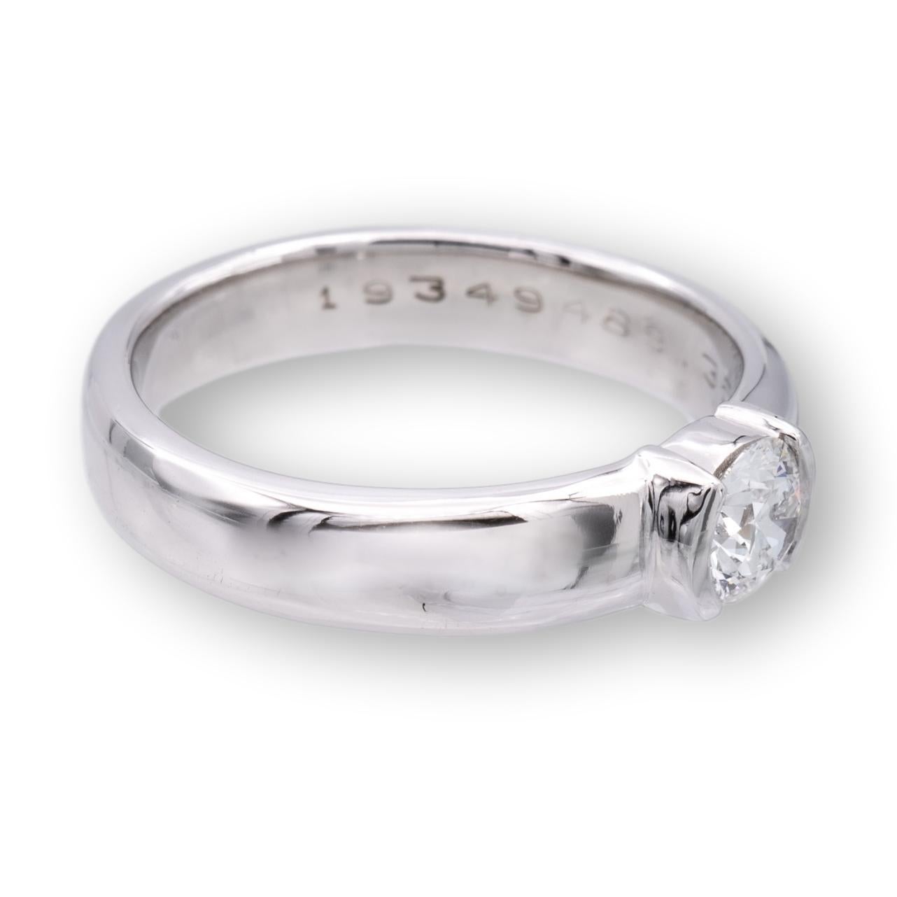 Tiffany and Co. engagement ring from the Etoile collection finely crafted in platinum featuring a round brilliant cut diamond center weighing 0.35 cts. F color , VVS2 clarity set in a half bezel setting. The original Tiffany certificate for this
