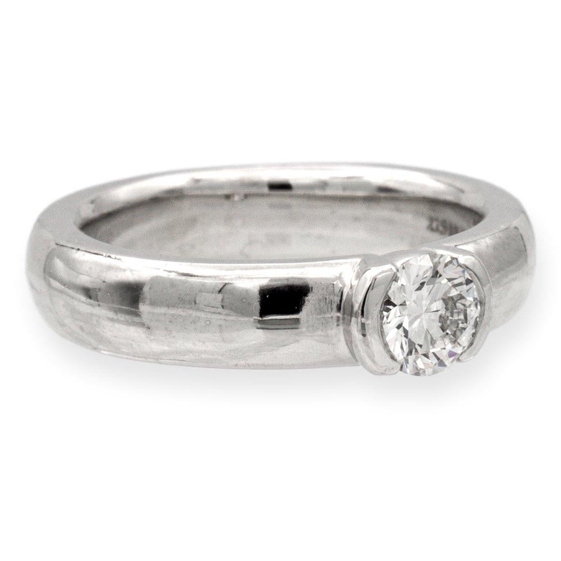 Tiffany and Co. engagement ring from the Etoile collection finely crafted in platinum featuring a round brilliant cut diamond center weighing 0.40 cts. F color , VVS1 clarity set in a half bezel setting. Fully hallmarked with Tiffany logos and metal