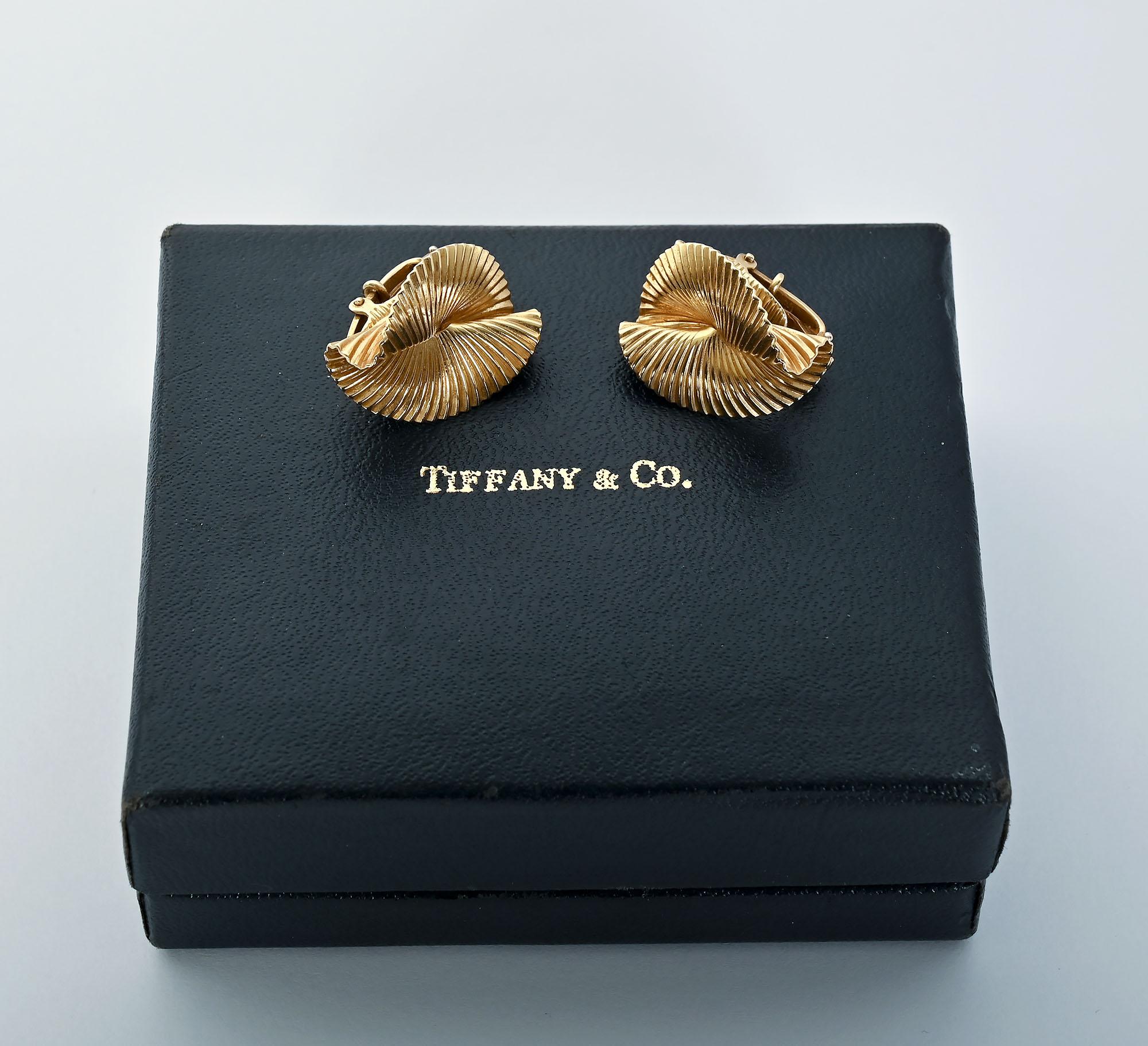 Classic Tiffany 14 karat gold earrings with a foldover design, a bit like origami.  The gold has a ribbed surface. The combination of the three dimensional shape as well as the texture make these earrings most interesting.
Clip backs can be