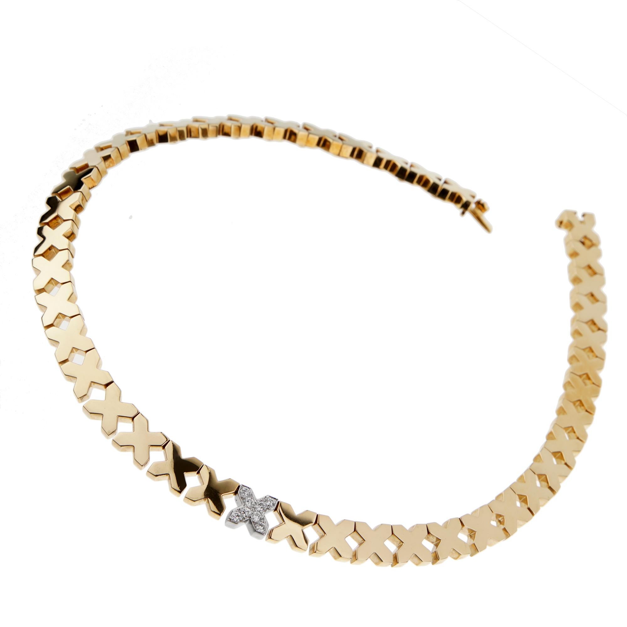 A chic vintage Tiffany & Co necklace showcasing gold X motifs and one diamond set white gold X motif. The necklace is crafted in 18k yellow and white gold and measures 14