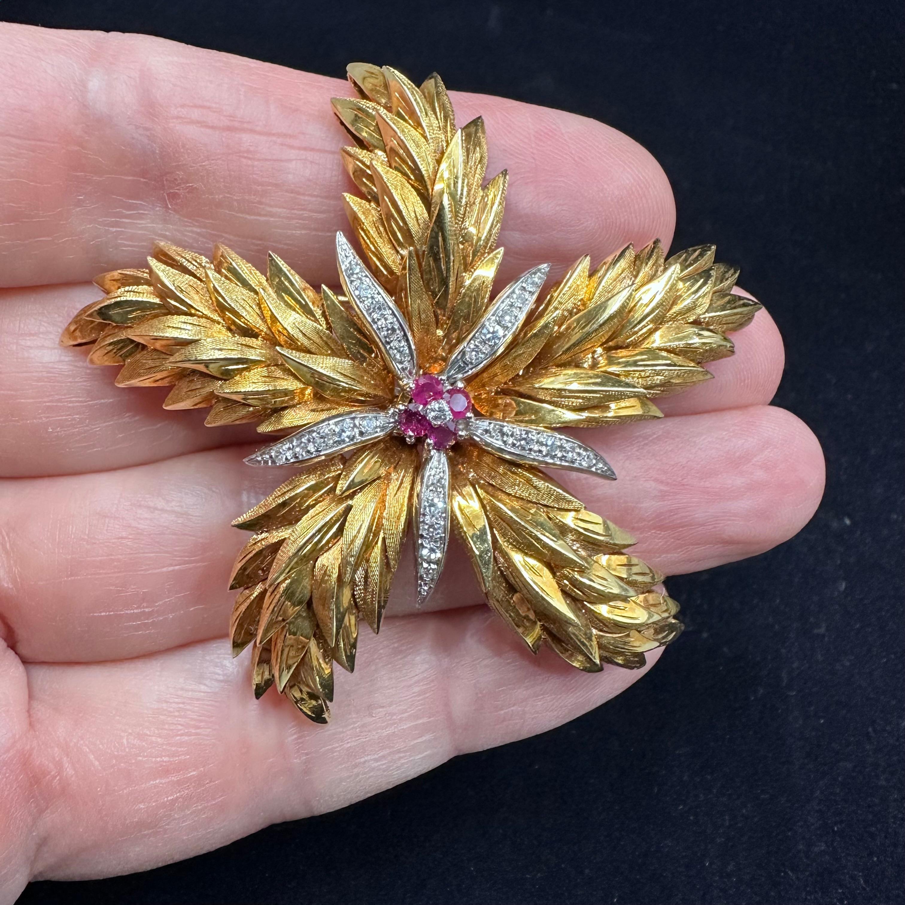 Tiffany and Company
Pine Cone Motif Large Brooch 2.5 Inches Diameter the center element consist of A Diamonds and Rubies Starburst 
18 k Yellow 23 g Weight.

