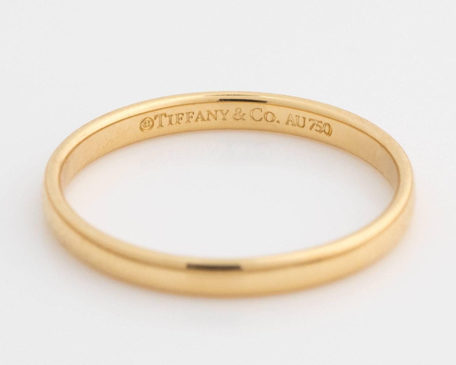 Tiffany and Co. Lucida 18 Karat Yellow Gold Wedding Band

This Tiffany and Co. Classic Ring is crafted from 18 Karat Yellow Gold. It has a high polish inside and out. 
The ring is 2 mm in height with a band thickness of 1 mm. There is room for an