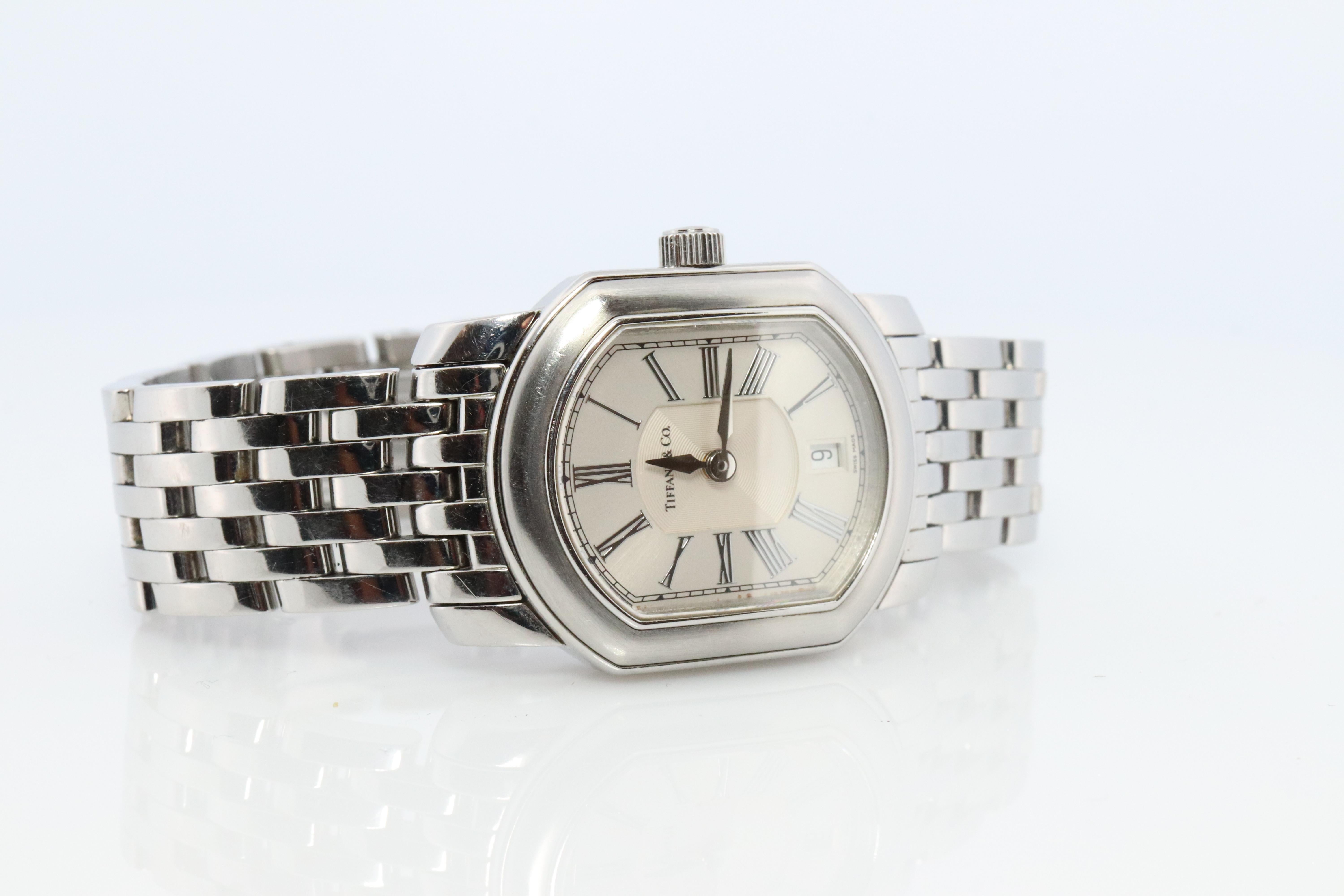 Tiffany and Co Coupe  Watch

Ladies Mark Coupe Resonator

Stainless Steel with Beautiful Silver Dial.
24mm by 28mm Case

Stainless steel case and bracelet.

Condition: New battery installed.
Quartz Movement